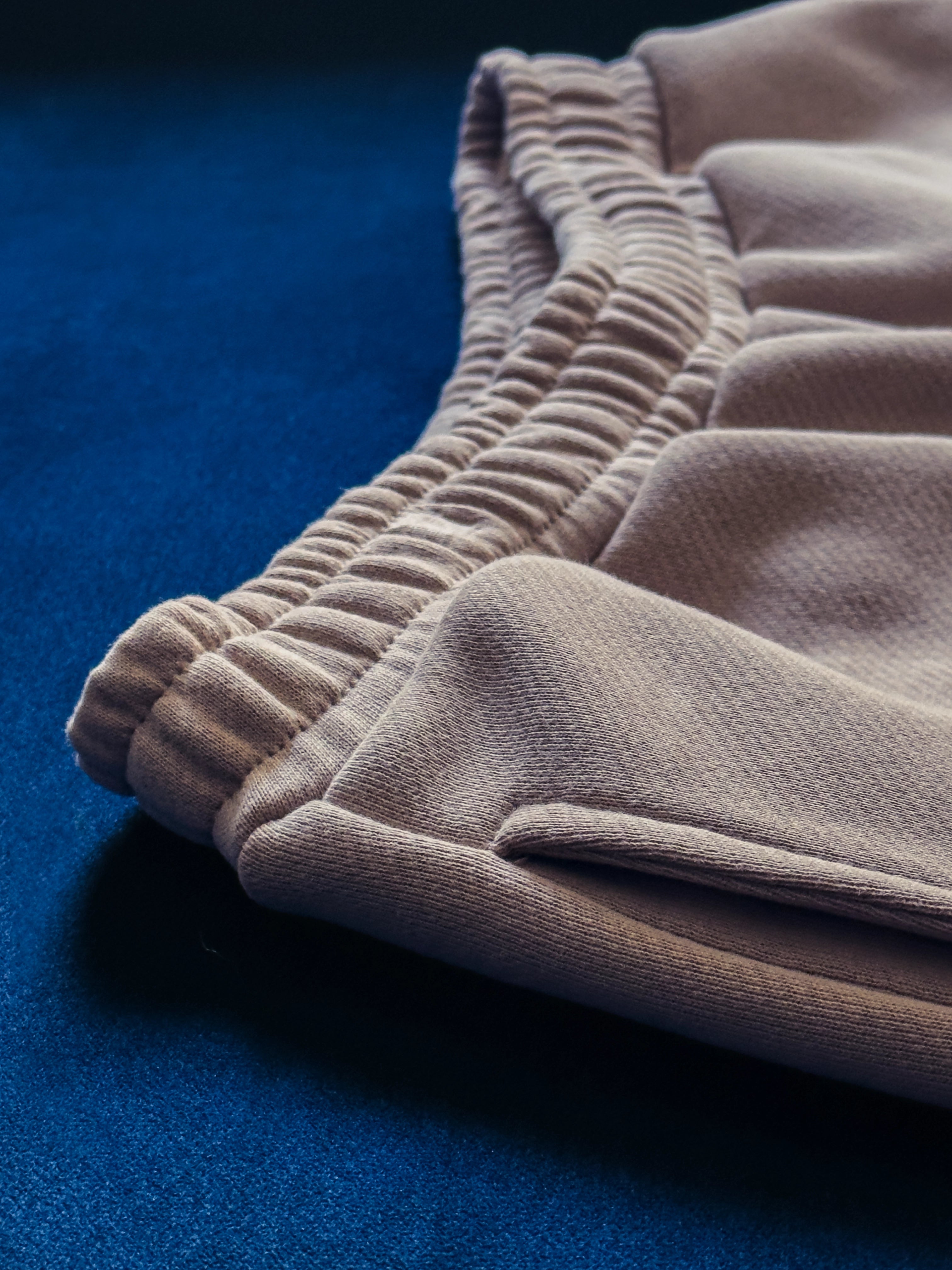 Close-up of a single green leaf against a white background.