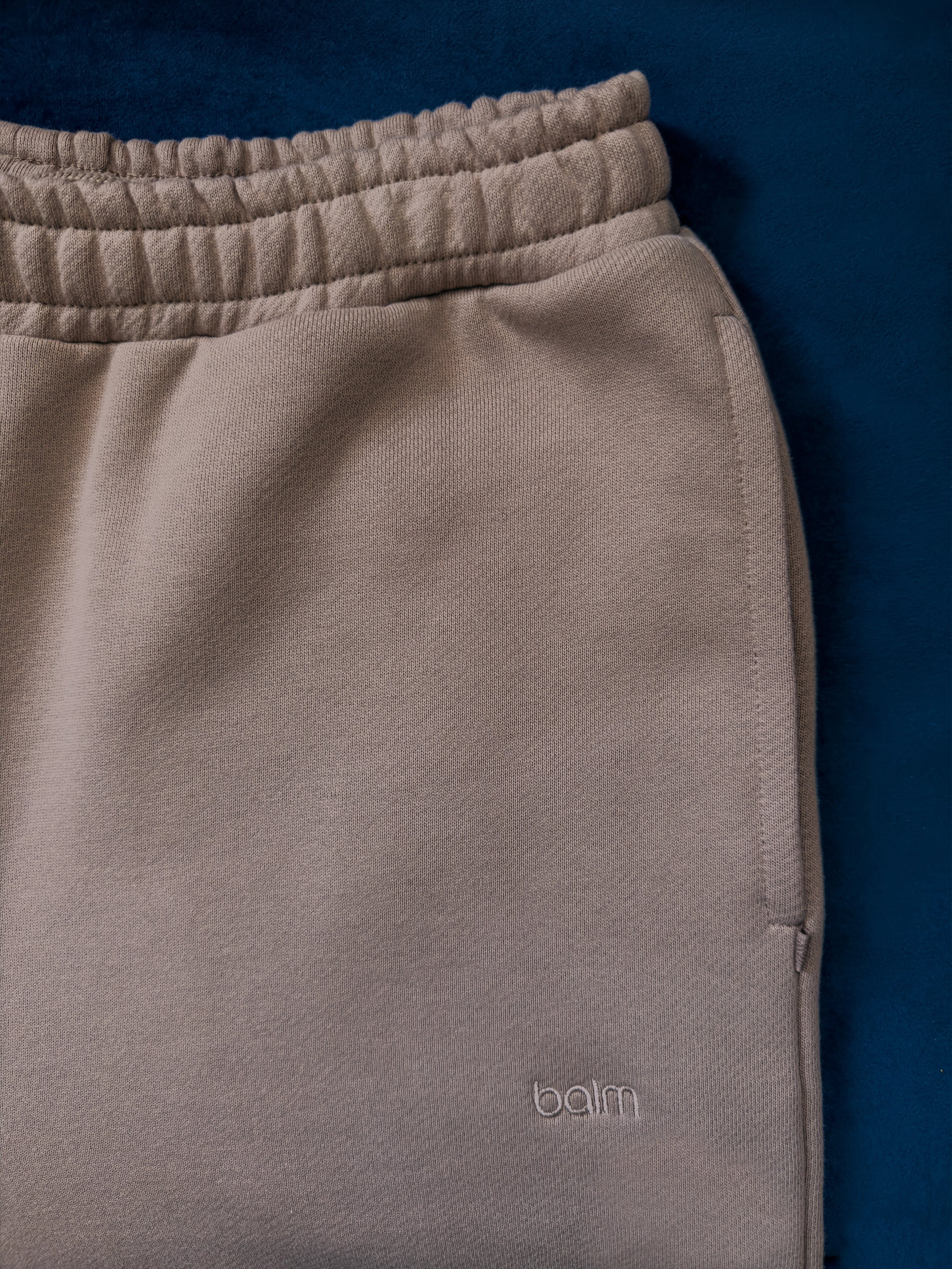 Close-up of a single green leaf against a white background.