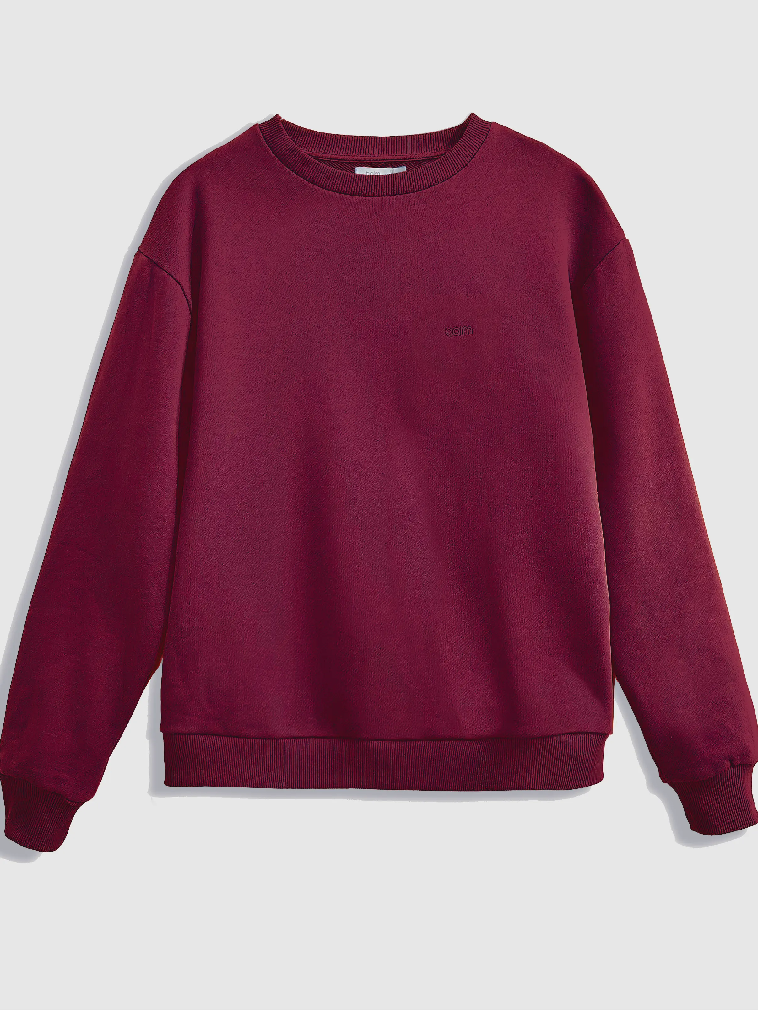 Close-up of a single green leaf against a white background.