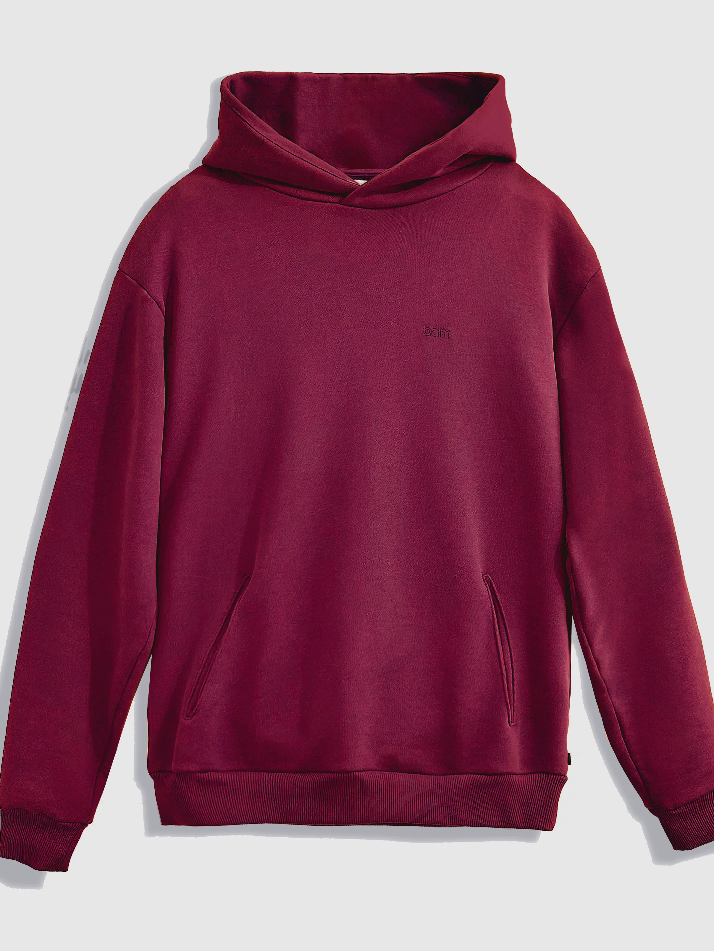 Close-up of a single green leaf against a white background.