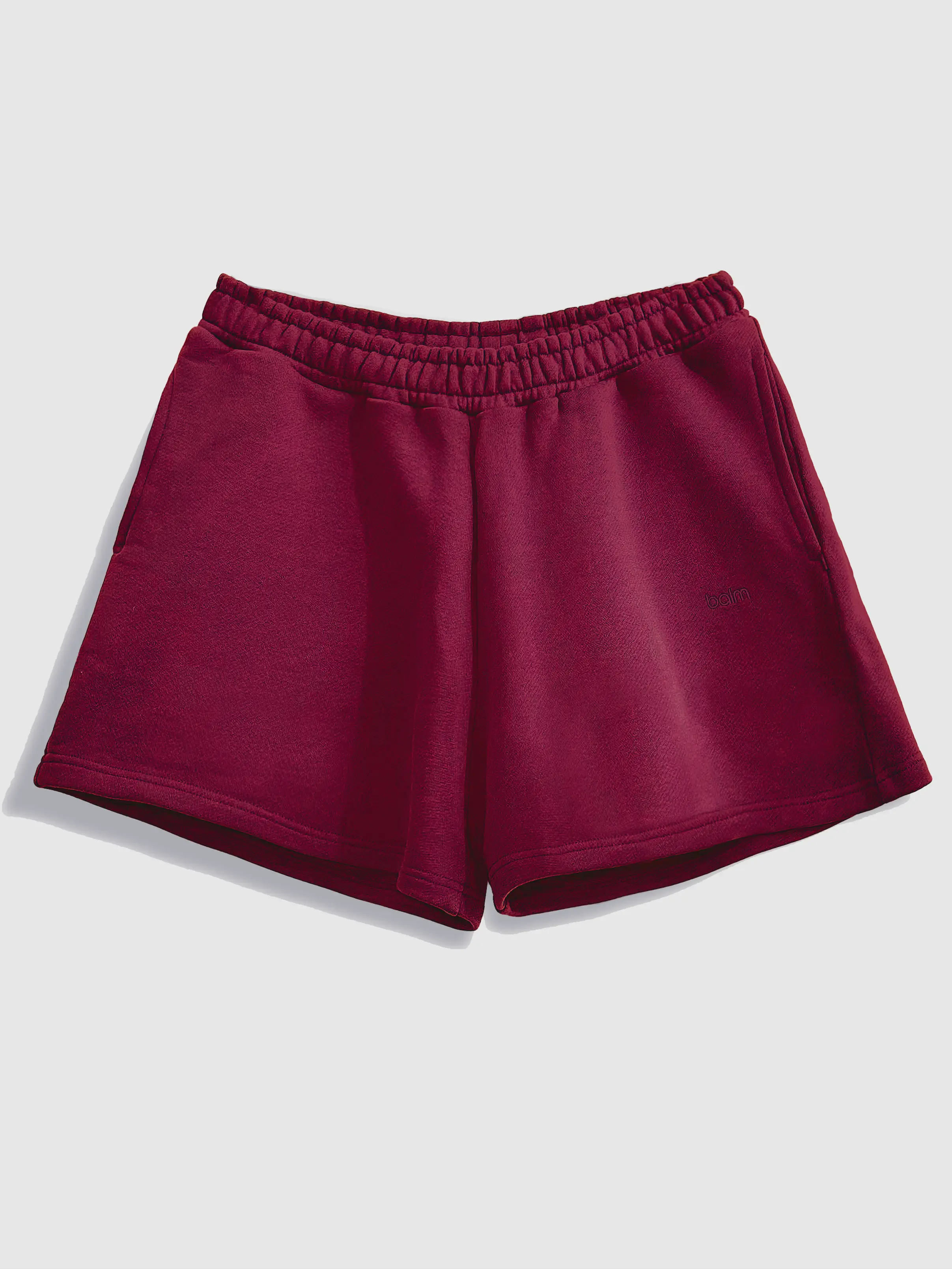 Close-up of a single green leaf against a white background.