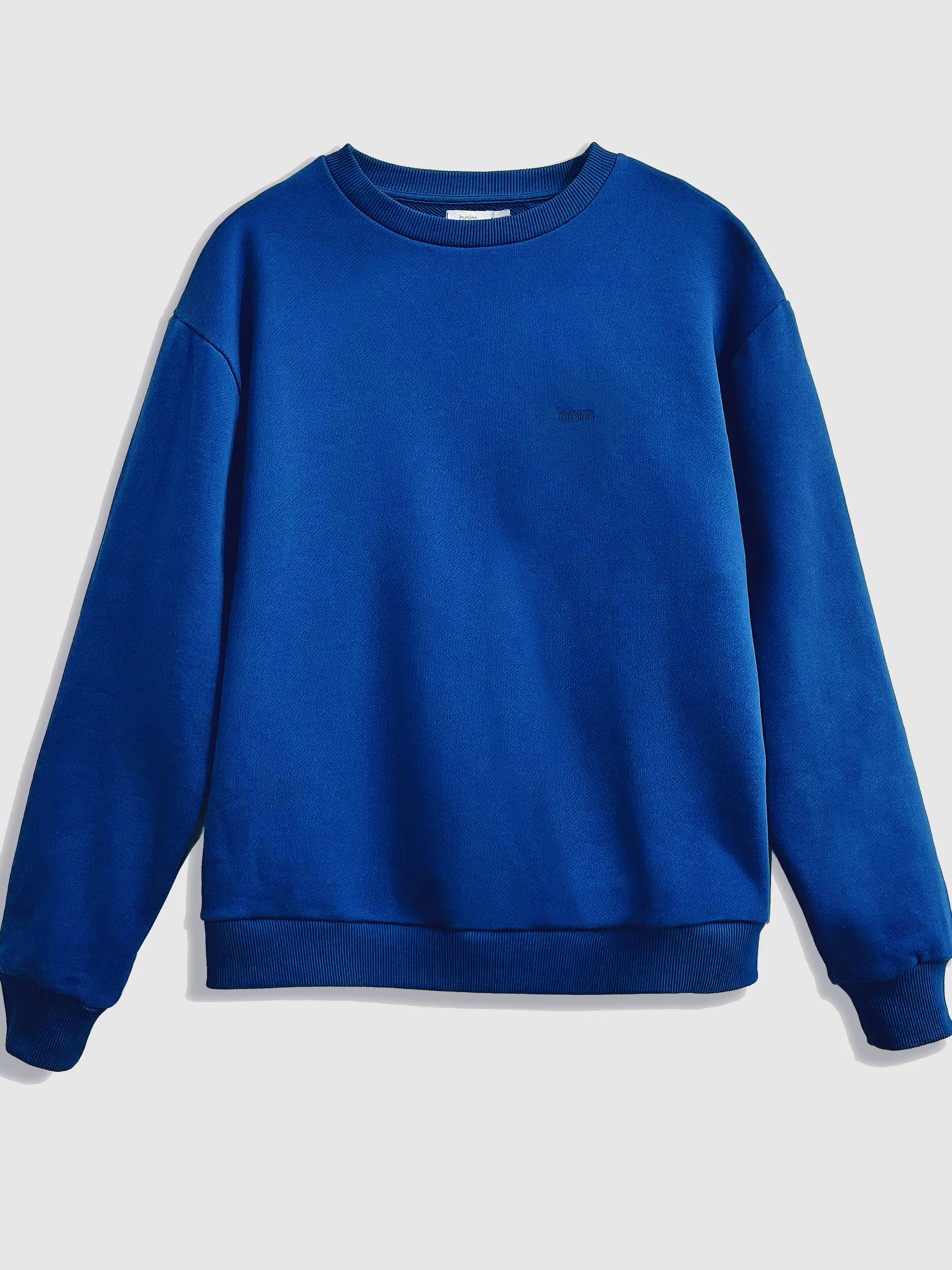 Close-up of a single green leaf against a white background.