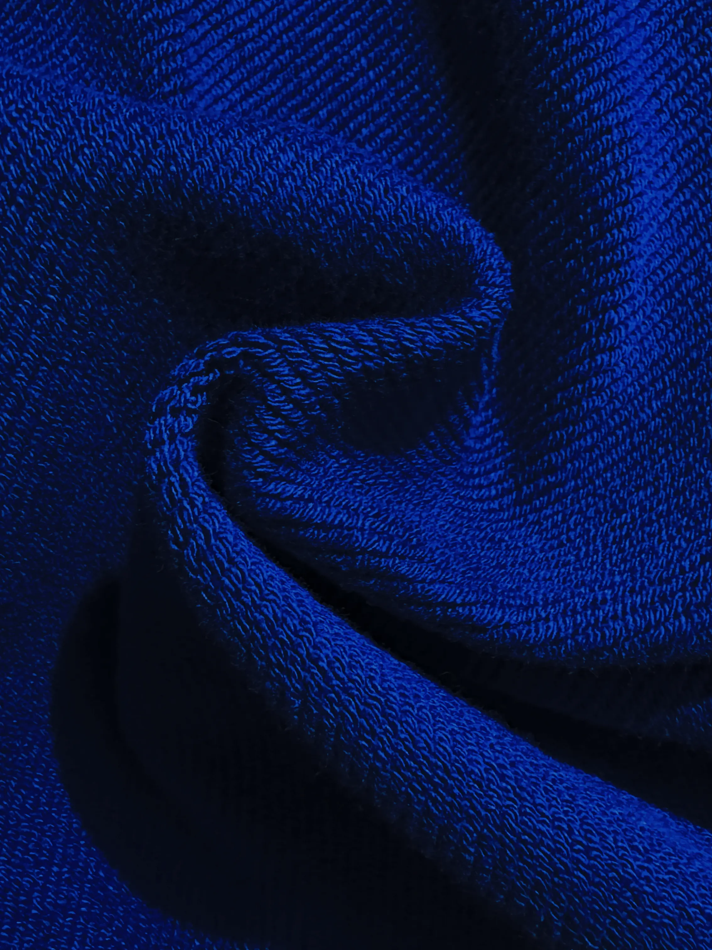 Close-up of a single green leaf against a white background.