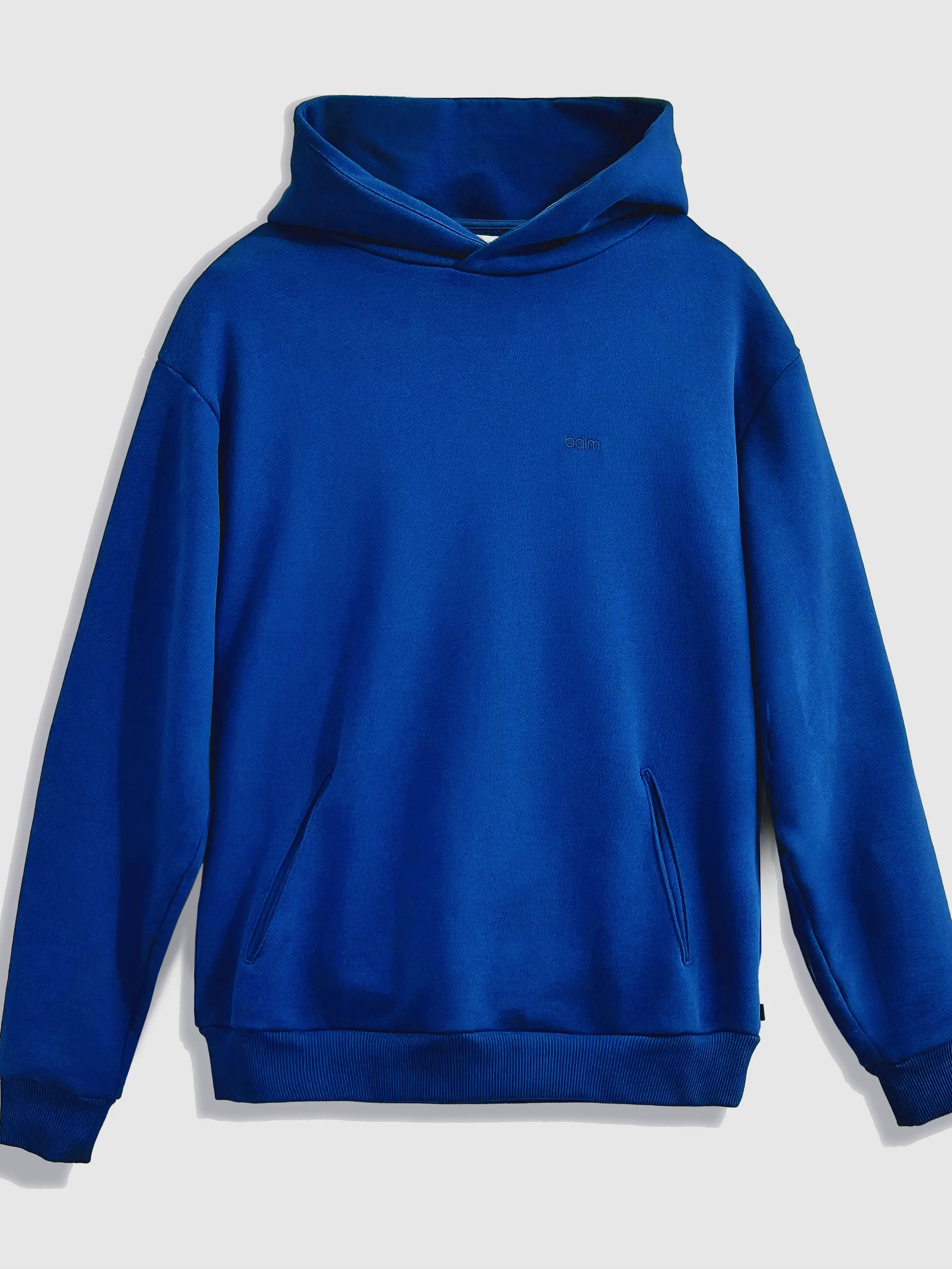 Close-up of a single green leaf against a white background.