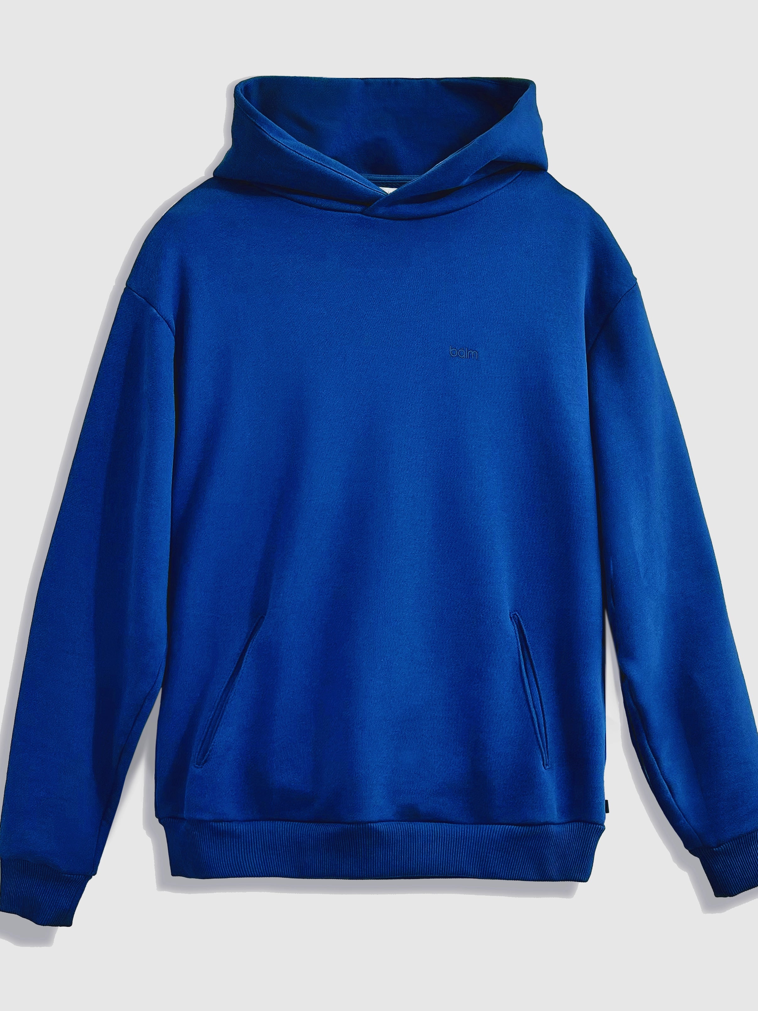 Close-up of a single green leaf against a white background.