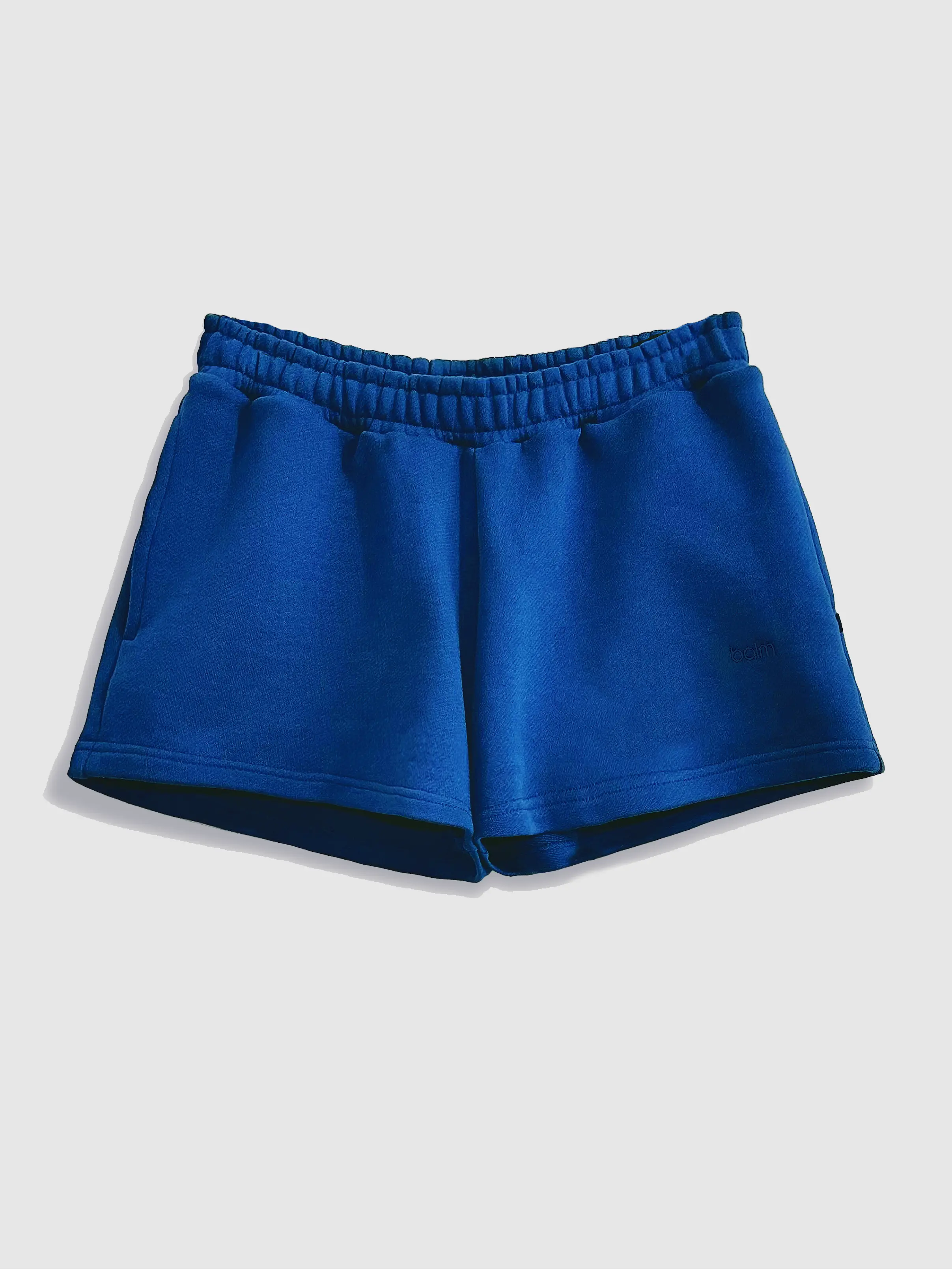 Close-up of a single green leaf against a white background.