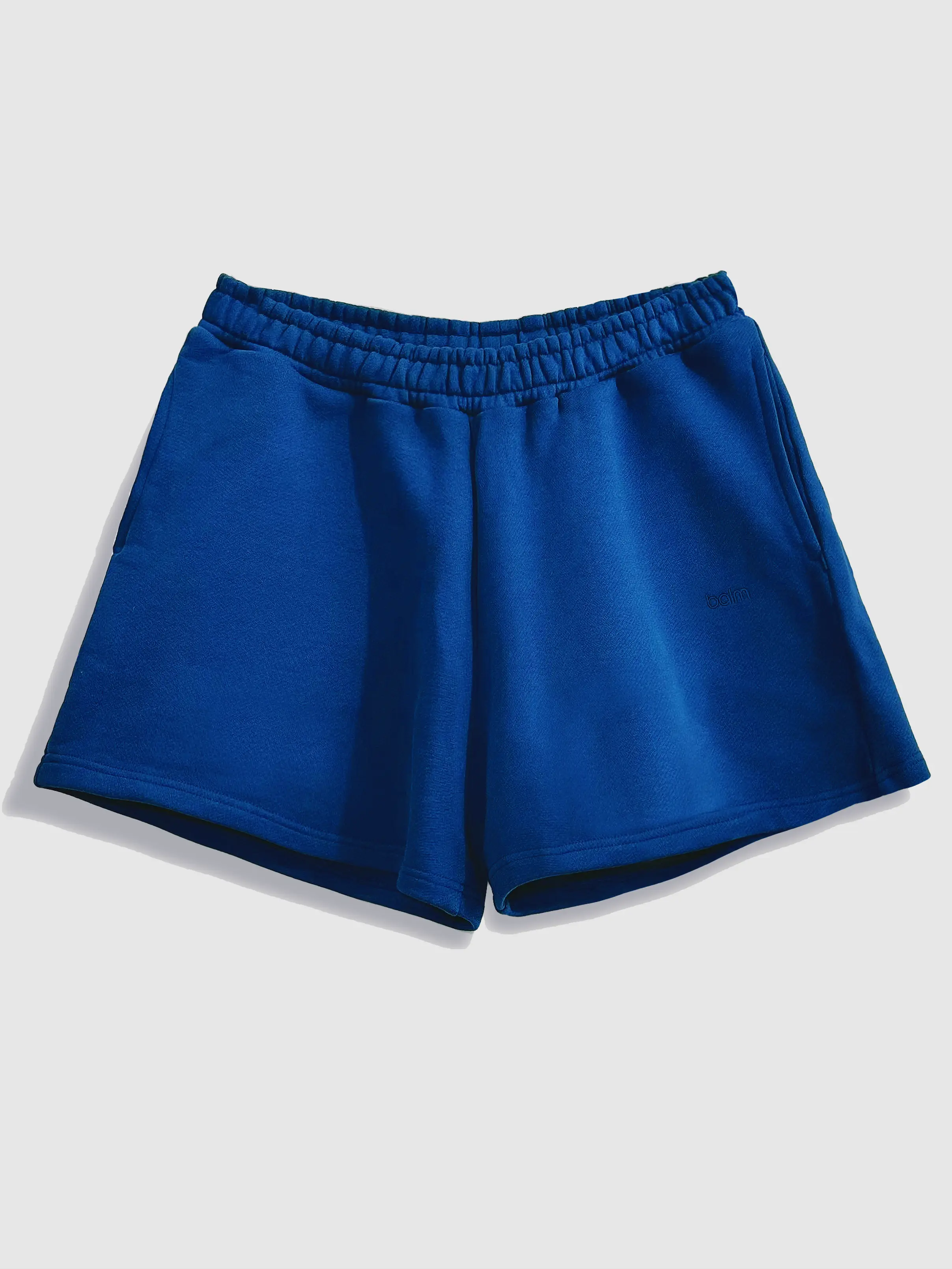 Close-up of a single green leaf against a white background.