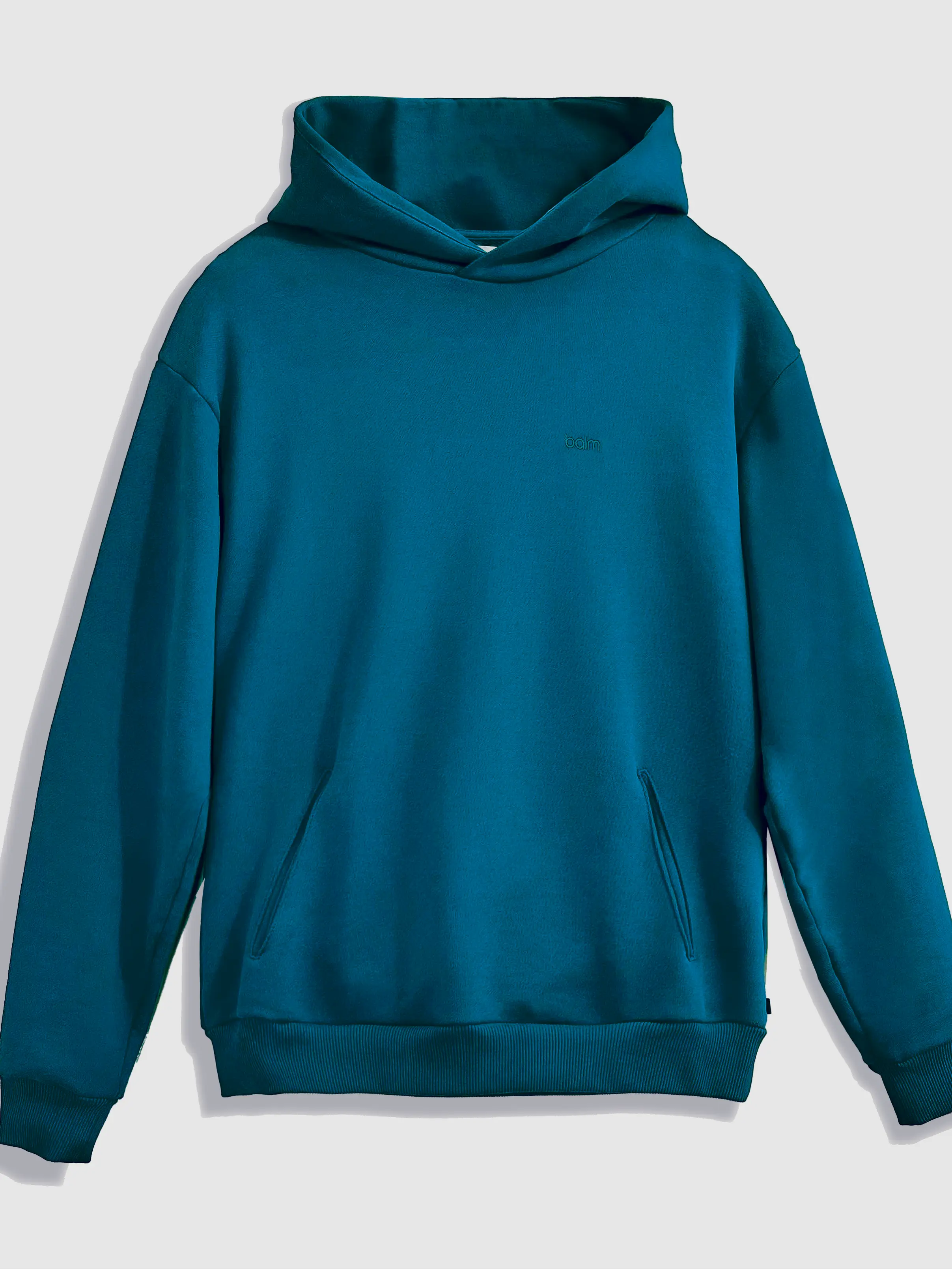 Close-up of a single green leaf against a white background.