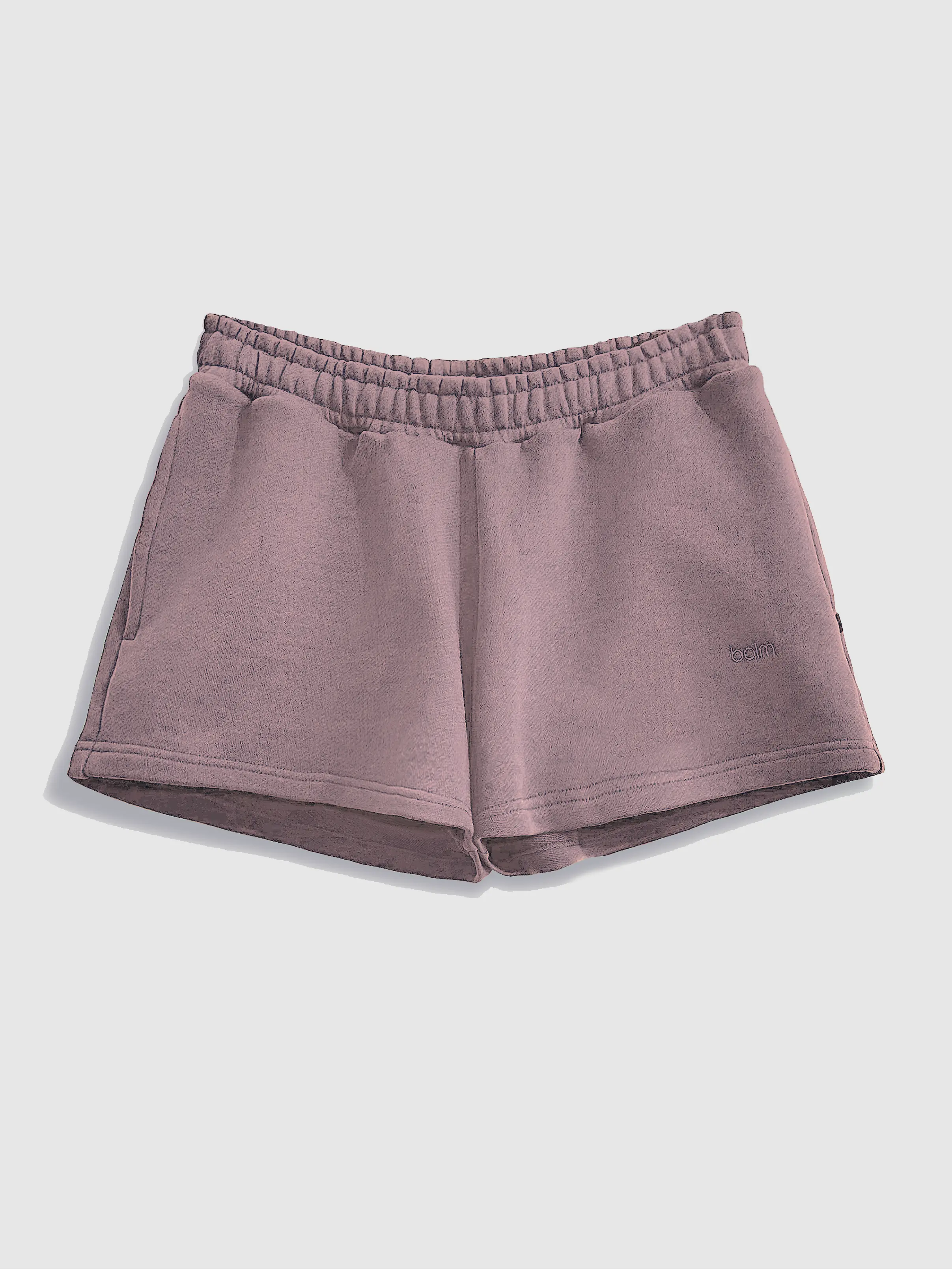 Close-up of a single green leaf against a white background.