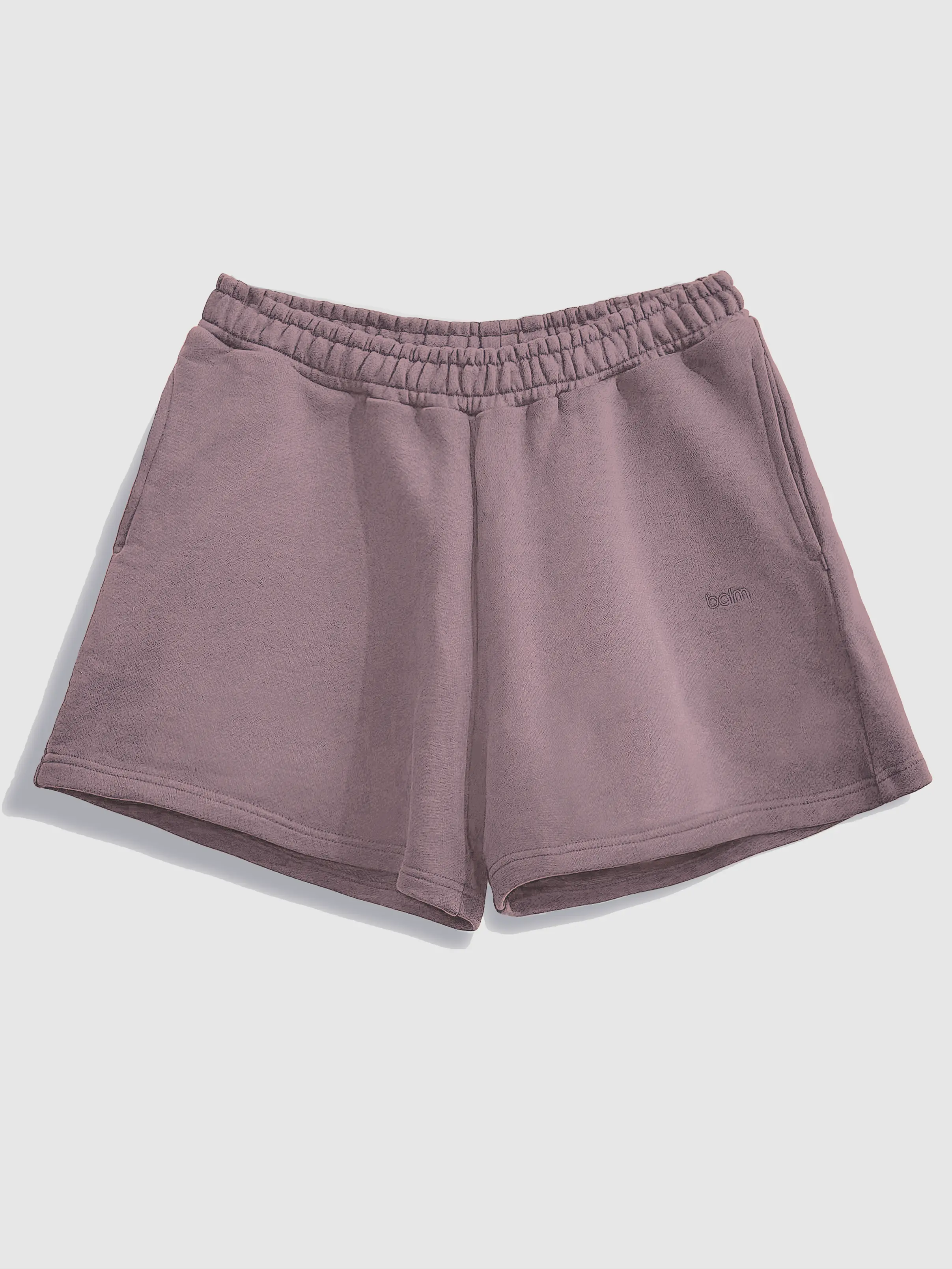 Close-up of a single green leaf against a white background.