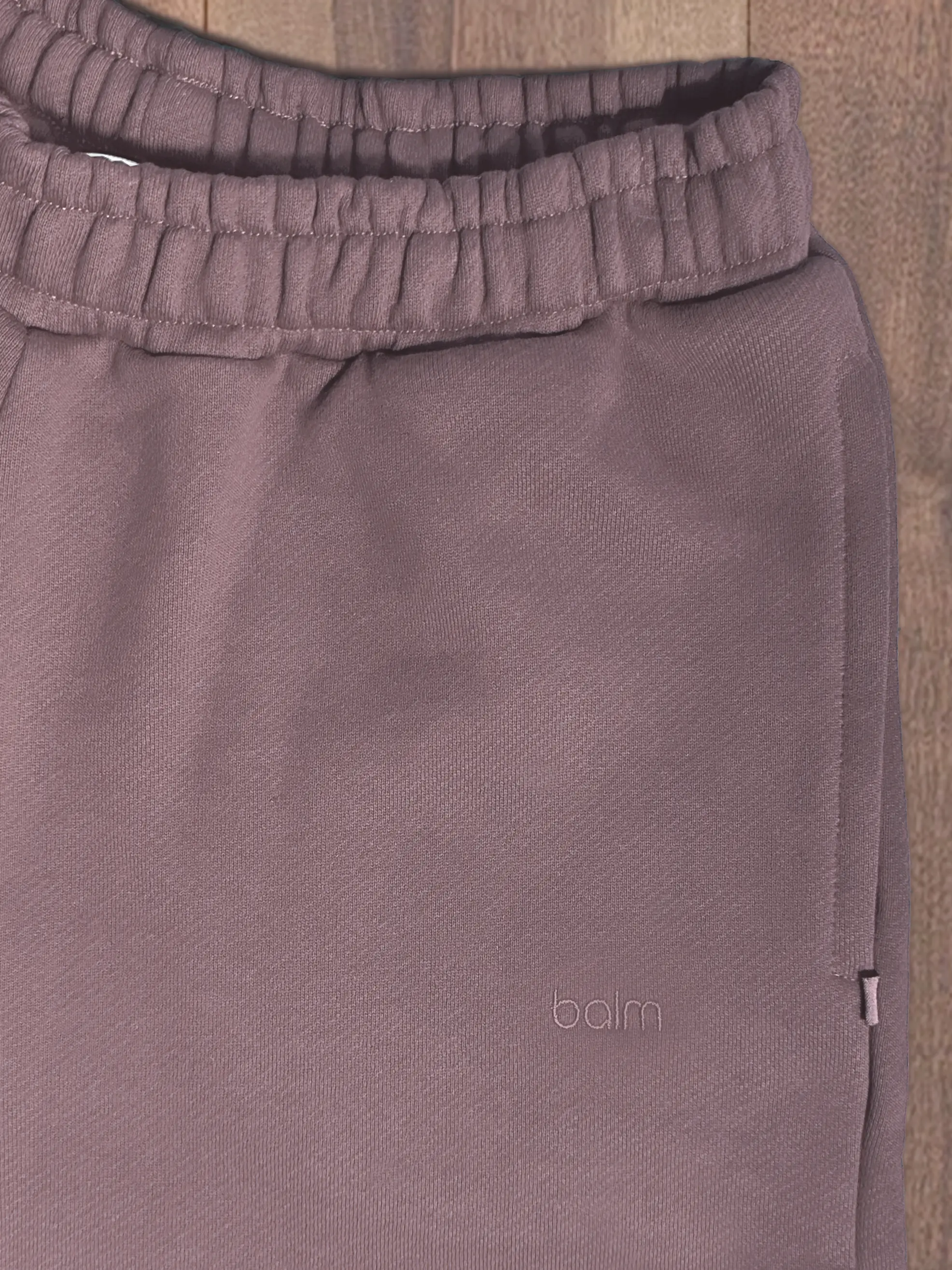 Close-up of a single green leaf against a white background.