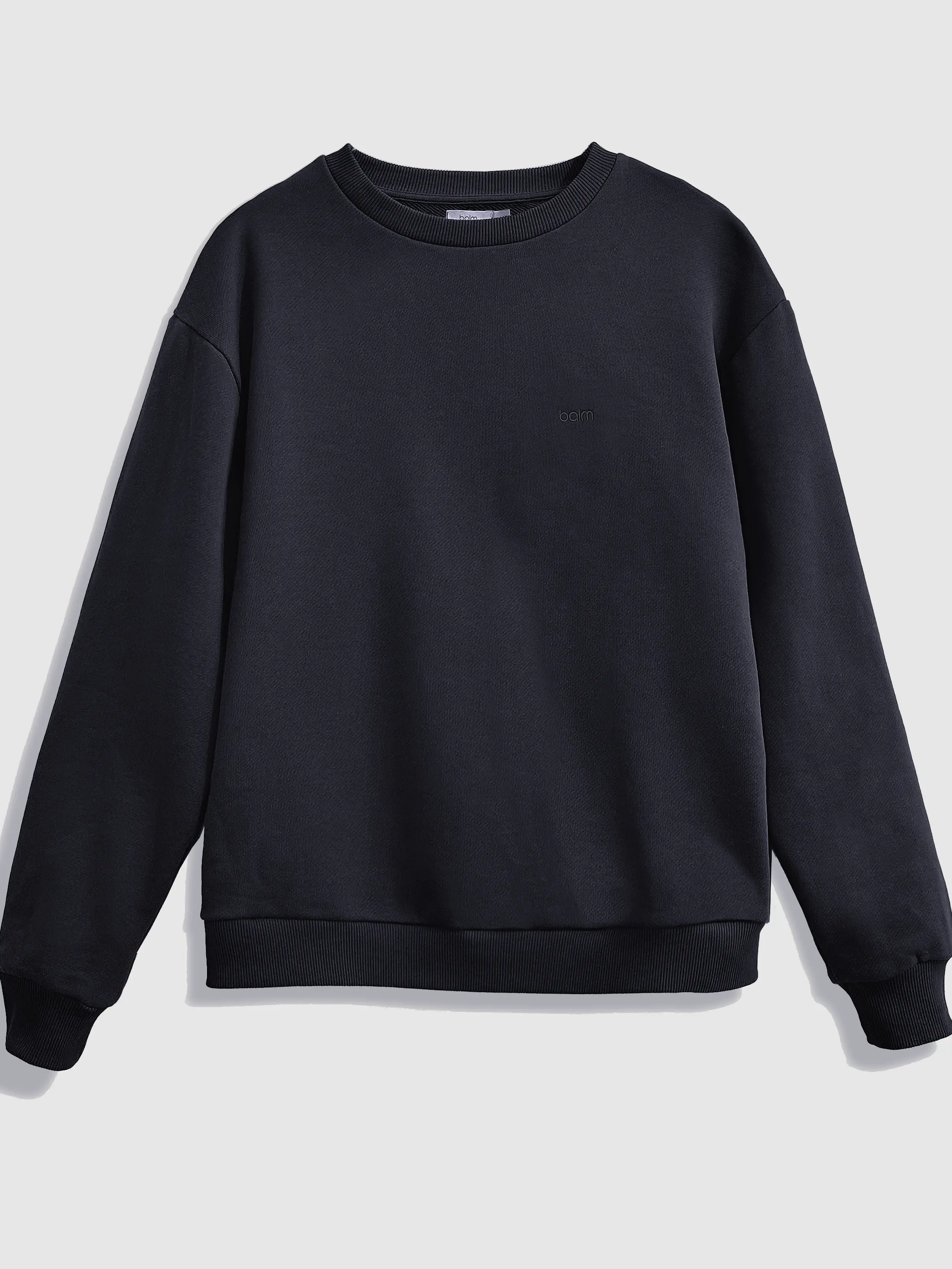 Close-up of a single green leaf against a white background.