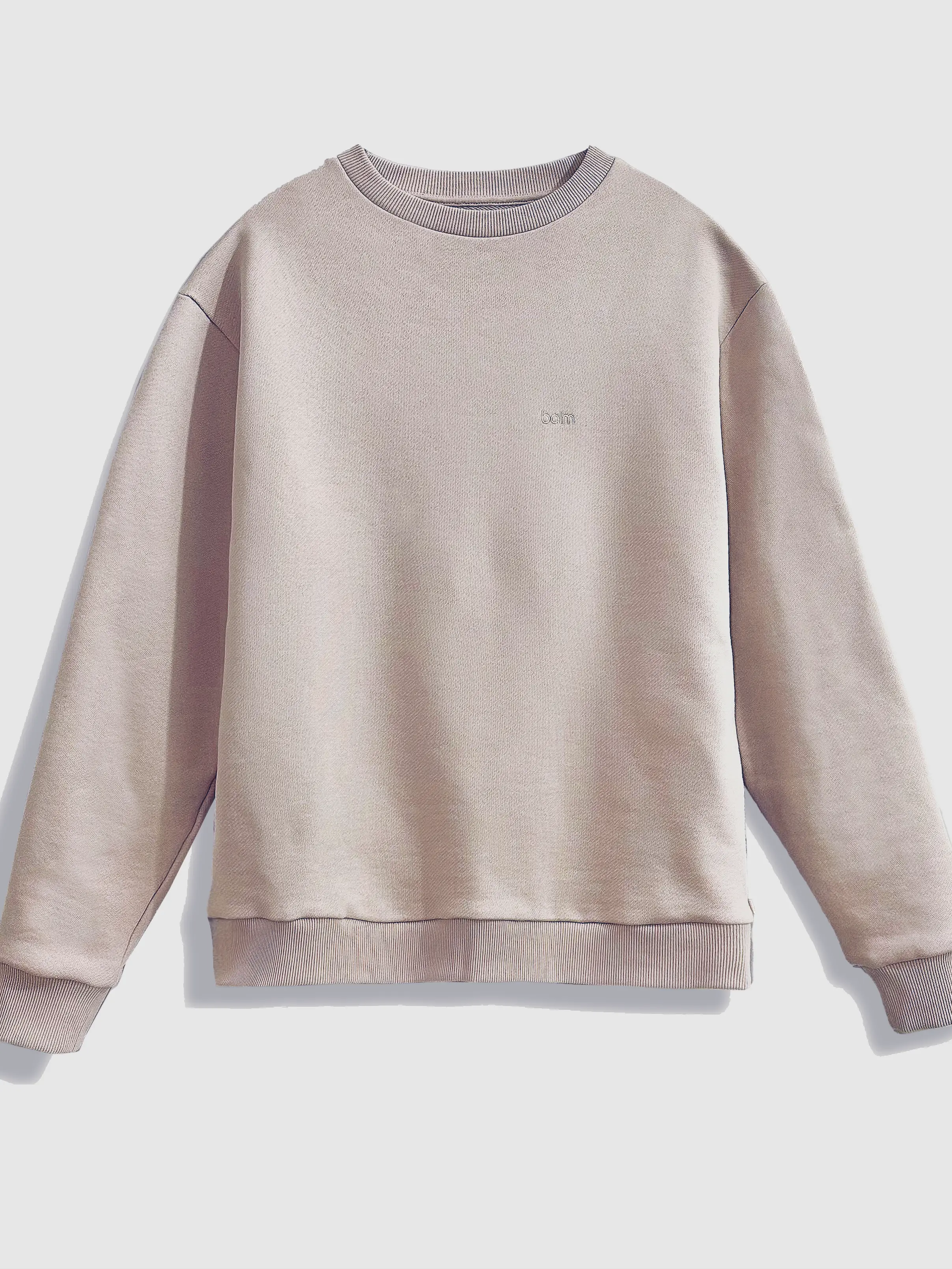 Close-up of a single green leaf against a white background.