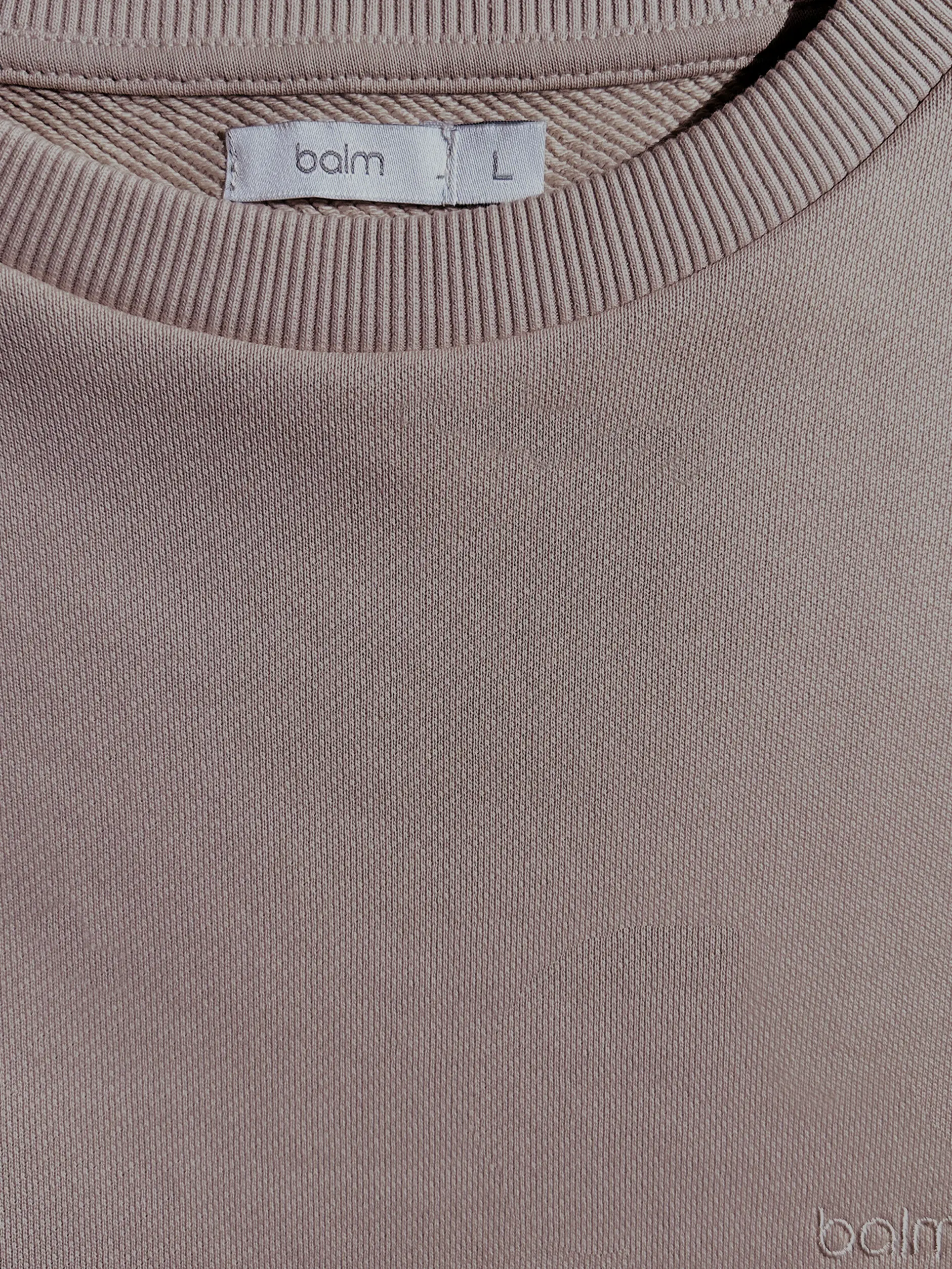 Close-up of a single green leaf against a white background.