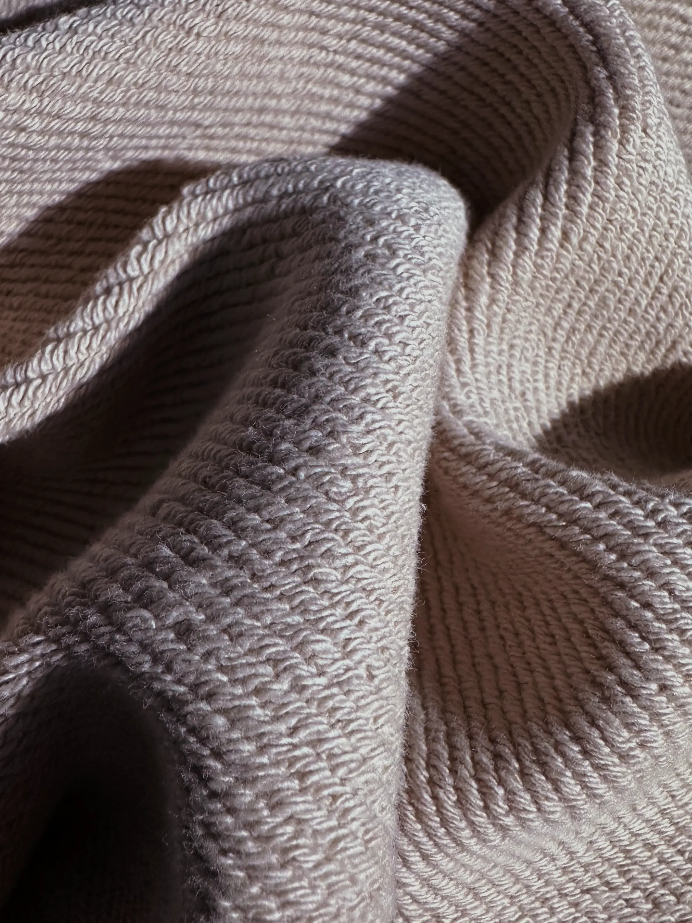 Close-up of a single green leaf against a white background.