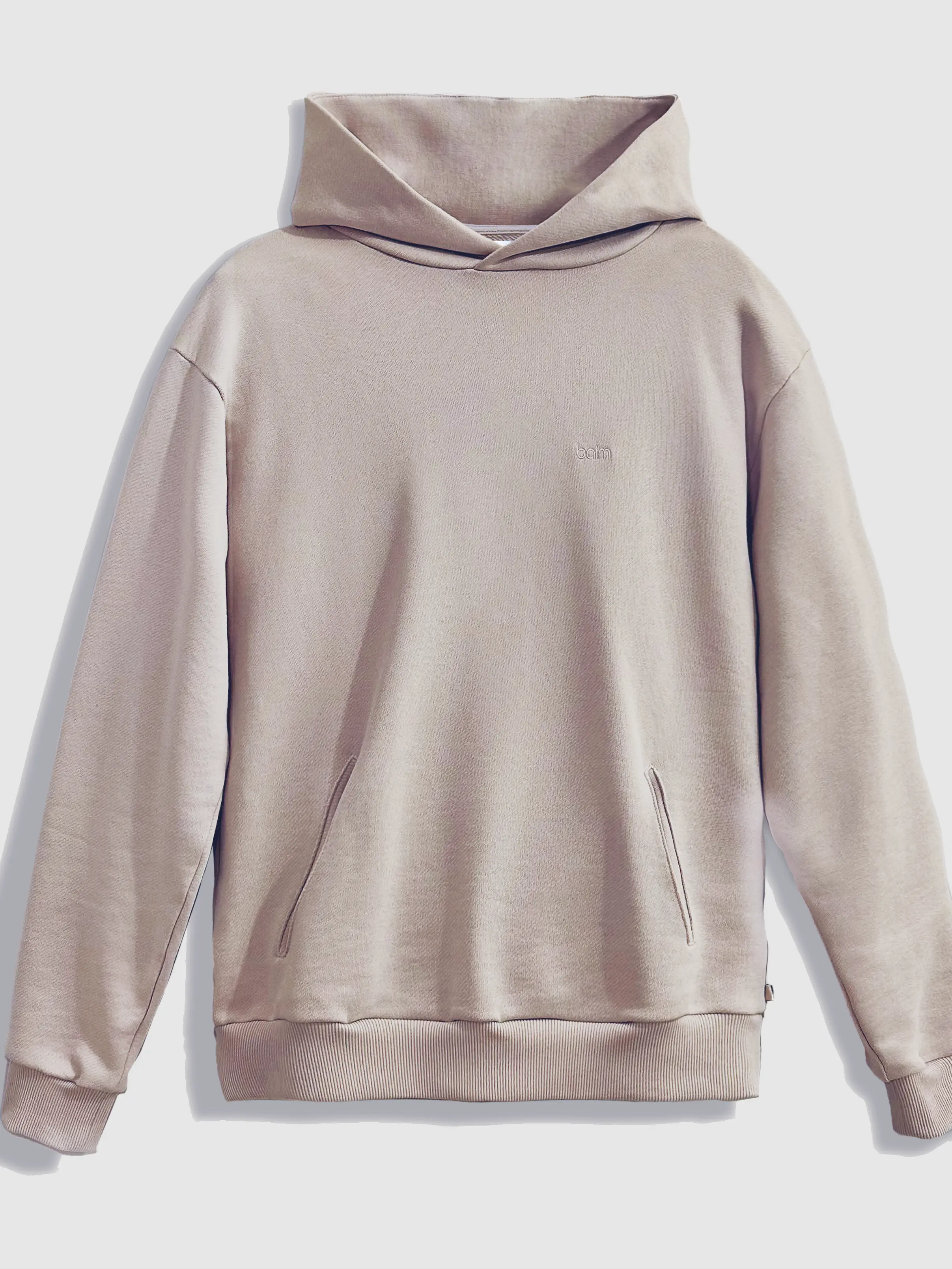 Close-up of a single green leaf against a white background.