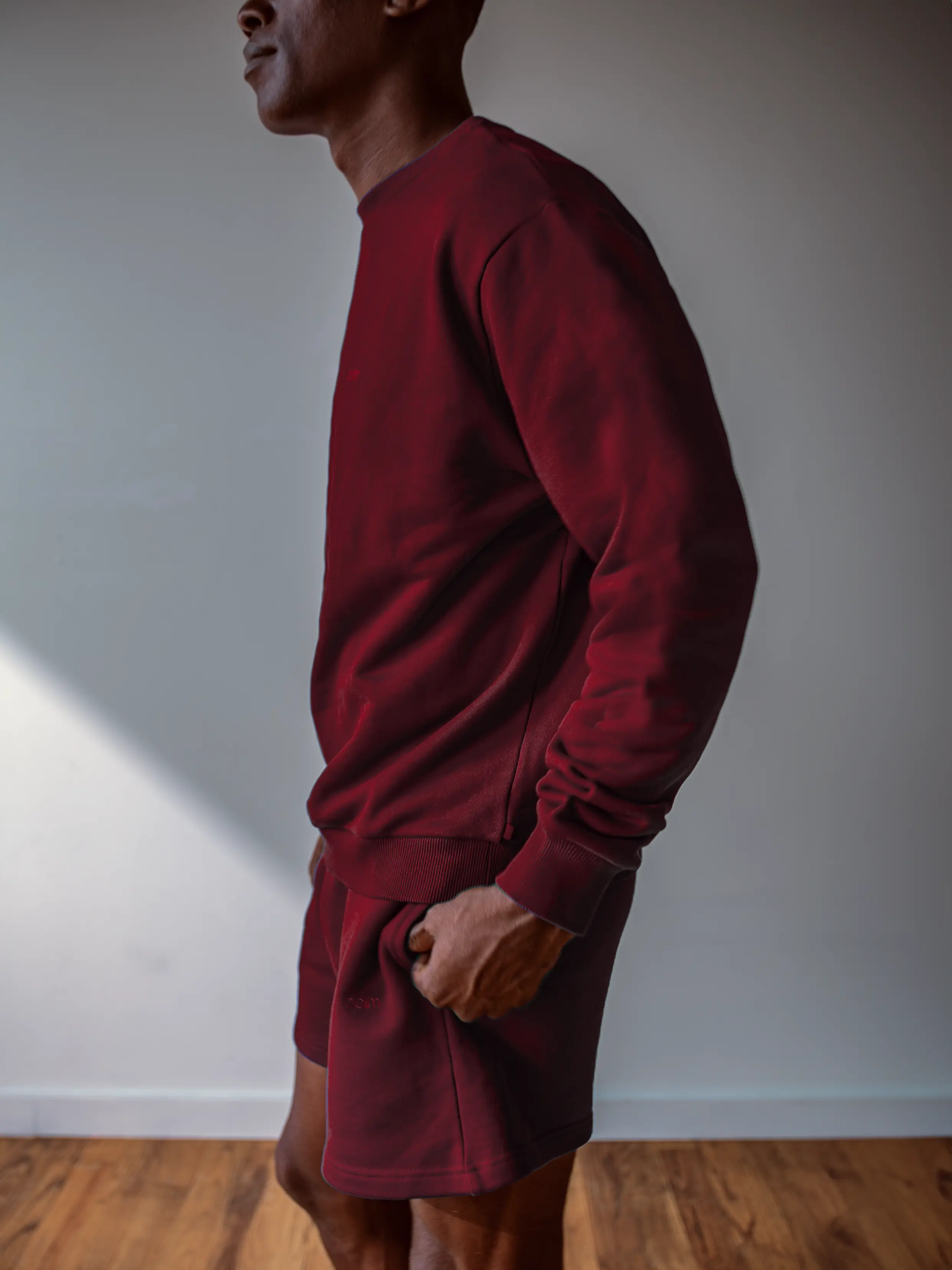 Close-up of a single green leaf against a white background.
