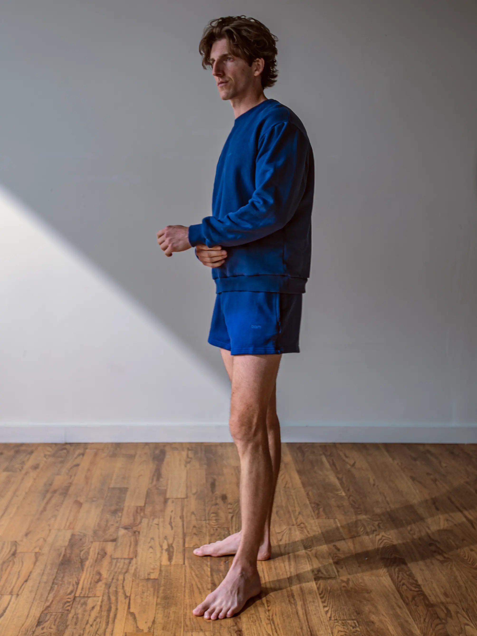 Close-up of a single green leaf against a white background.