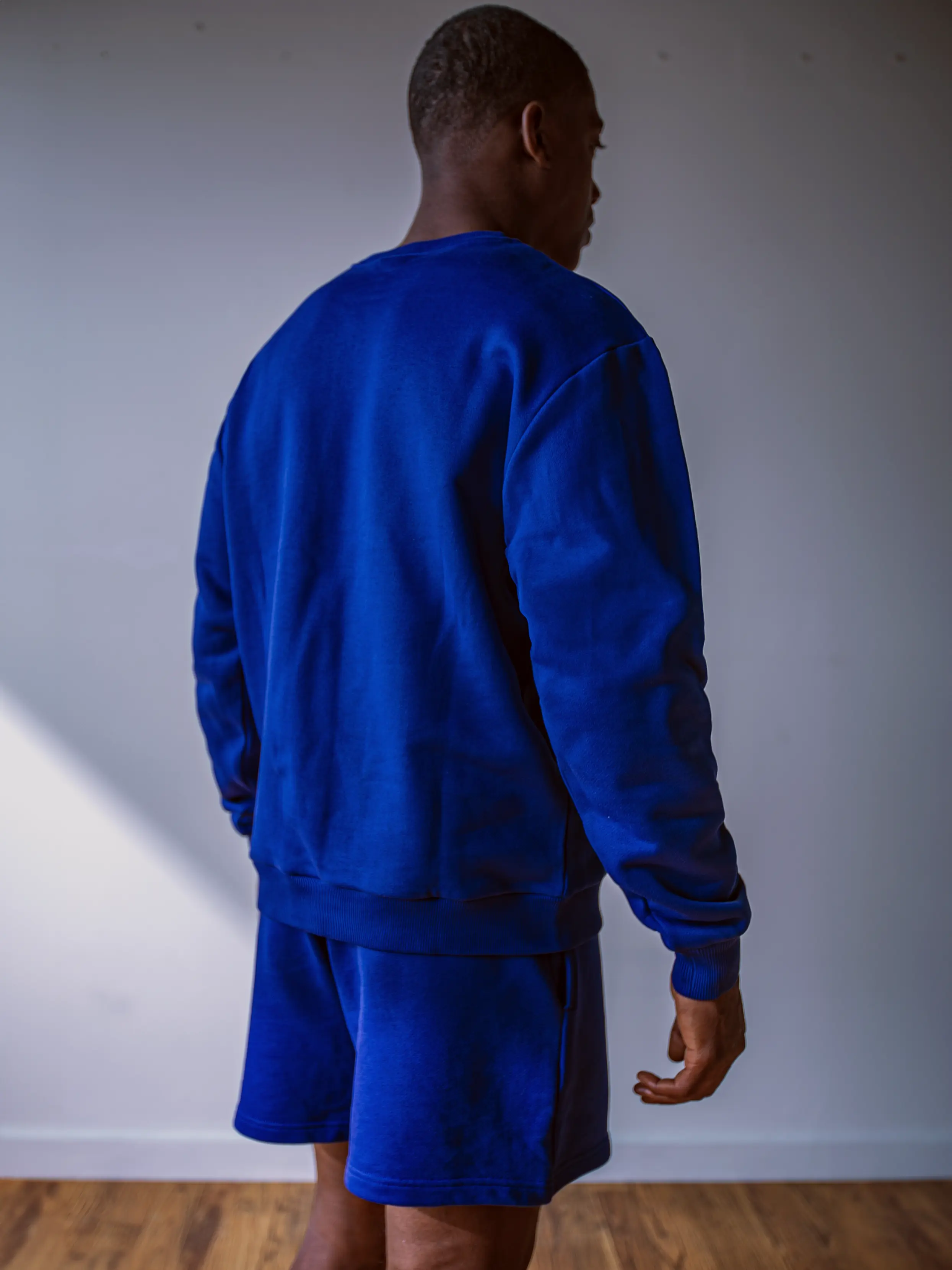 Close-up of a single green leaf against a white background.