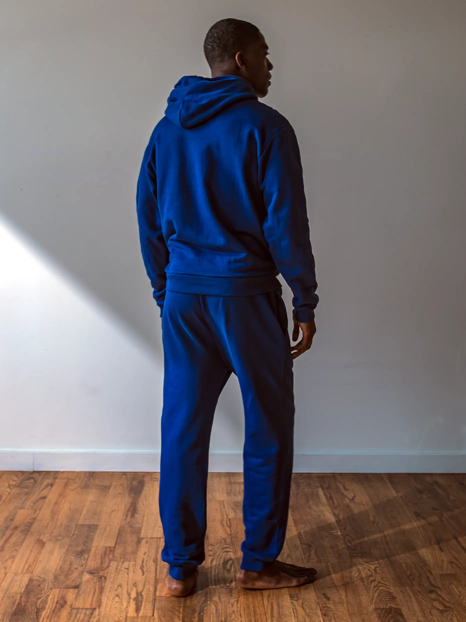 Close-up of a single green leaf against a white background.