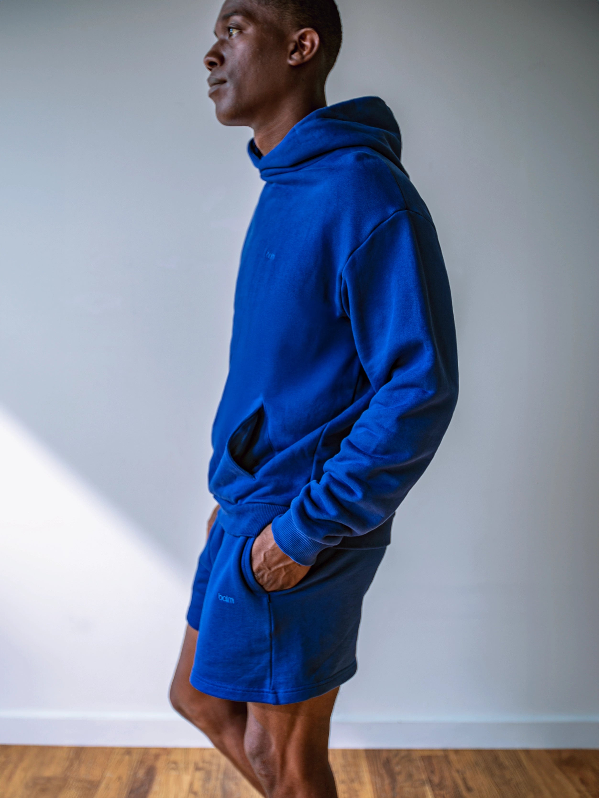 Close-up of a single green leaf against a white background.