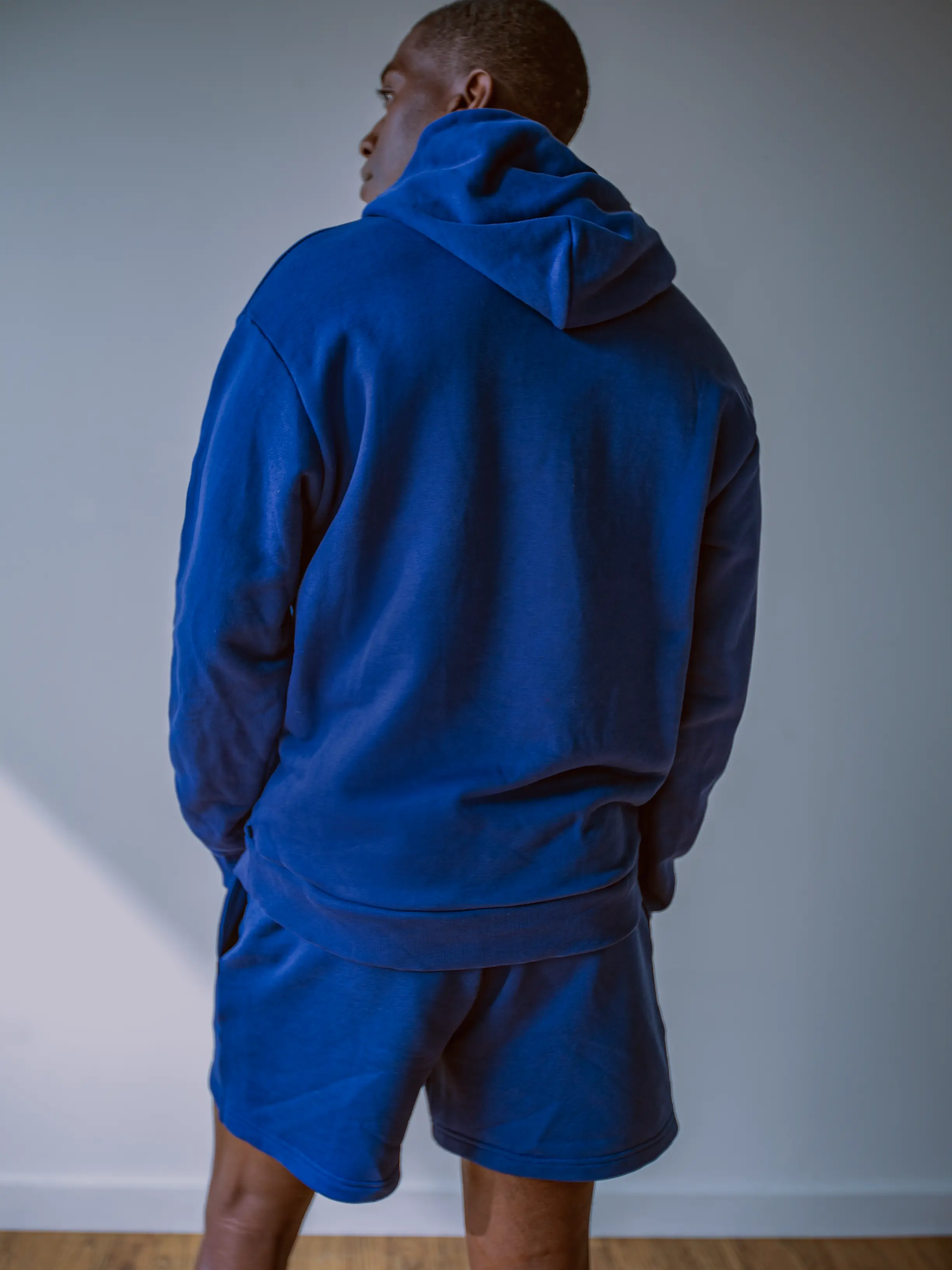 Close-up of a single green leaf against a white background.