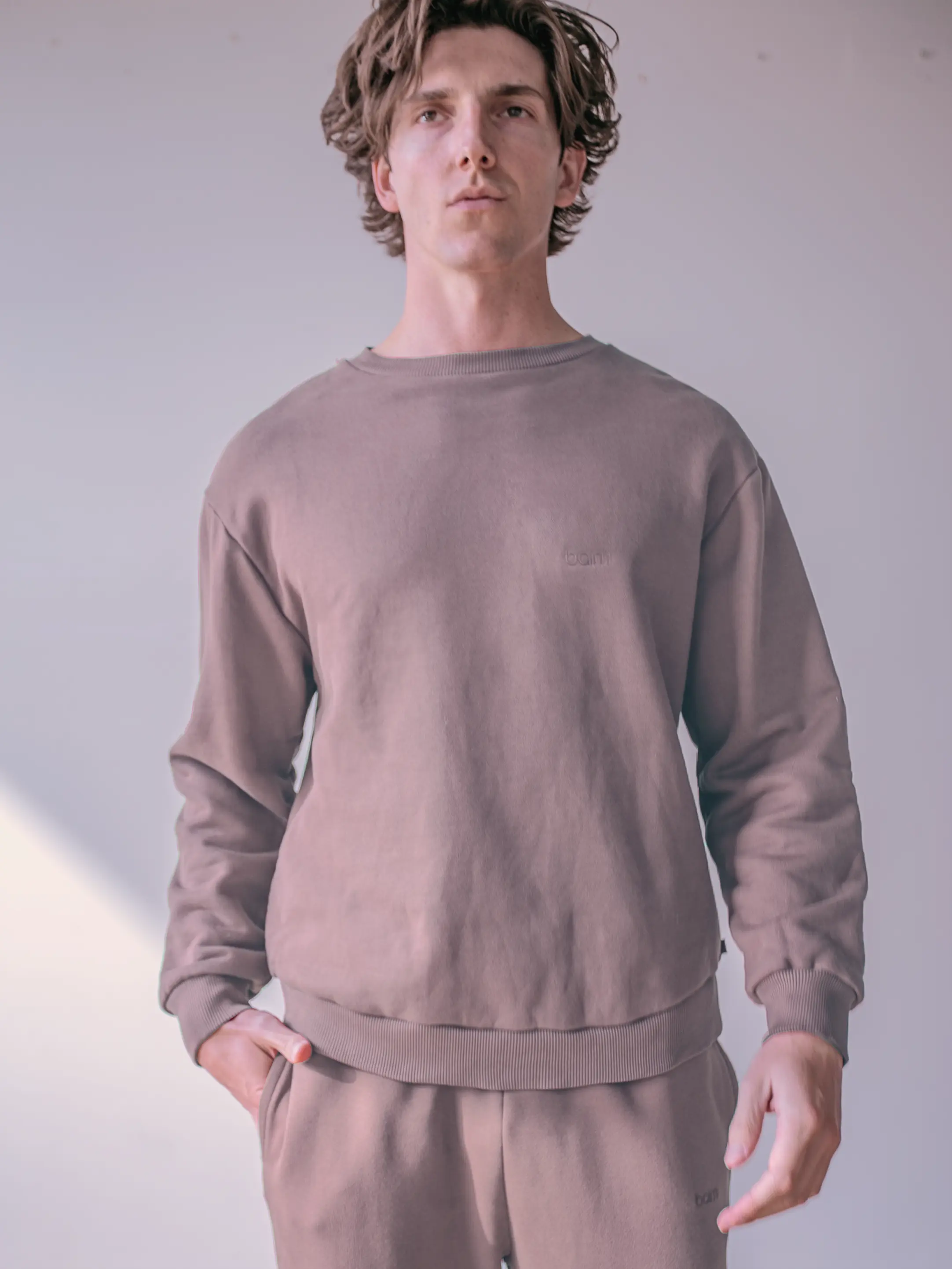 Close-up of a single green leaf against a white background.