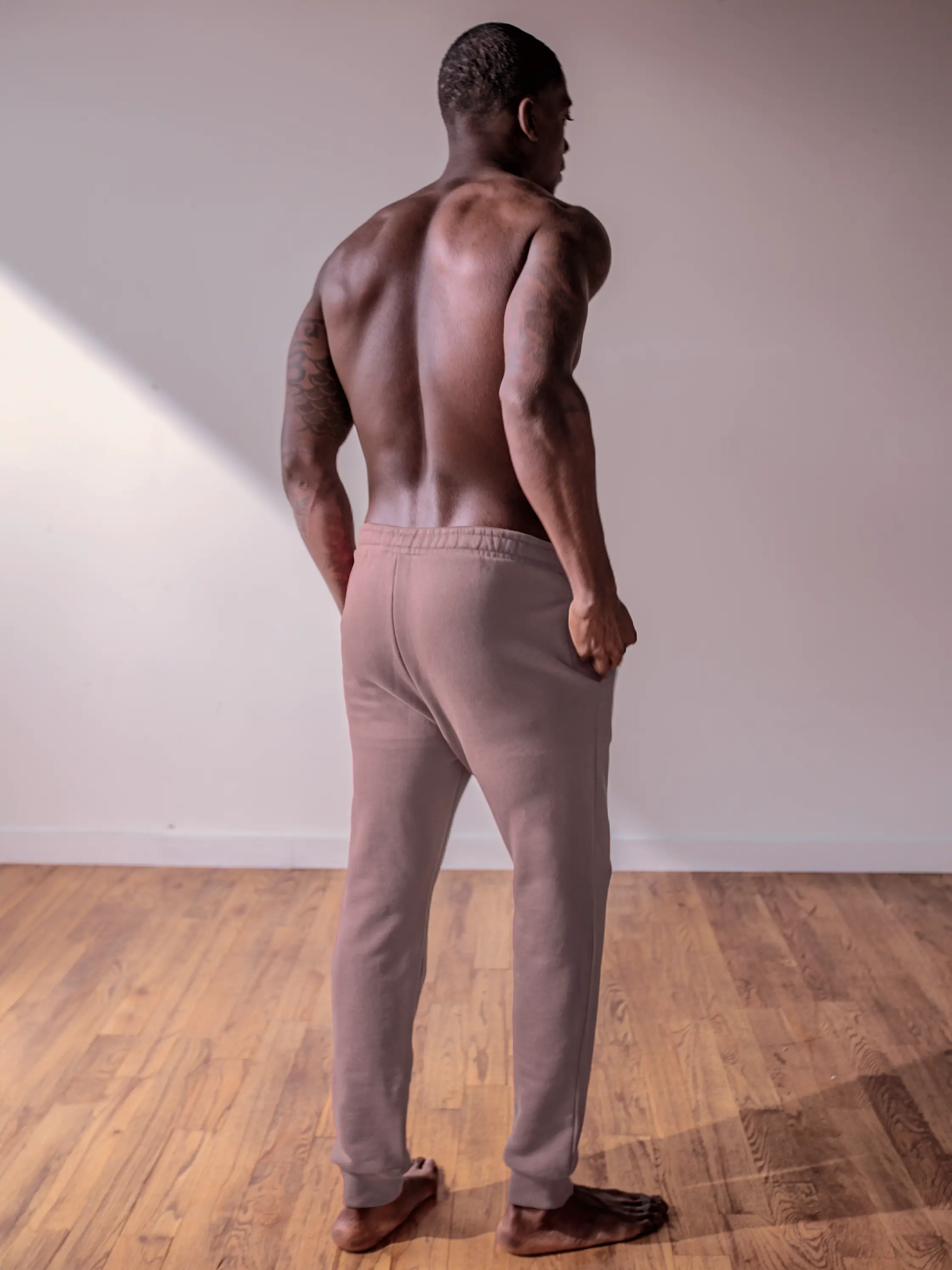 Close-up of a single green leaf against a white background.