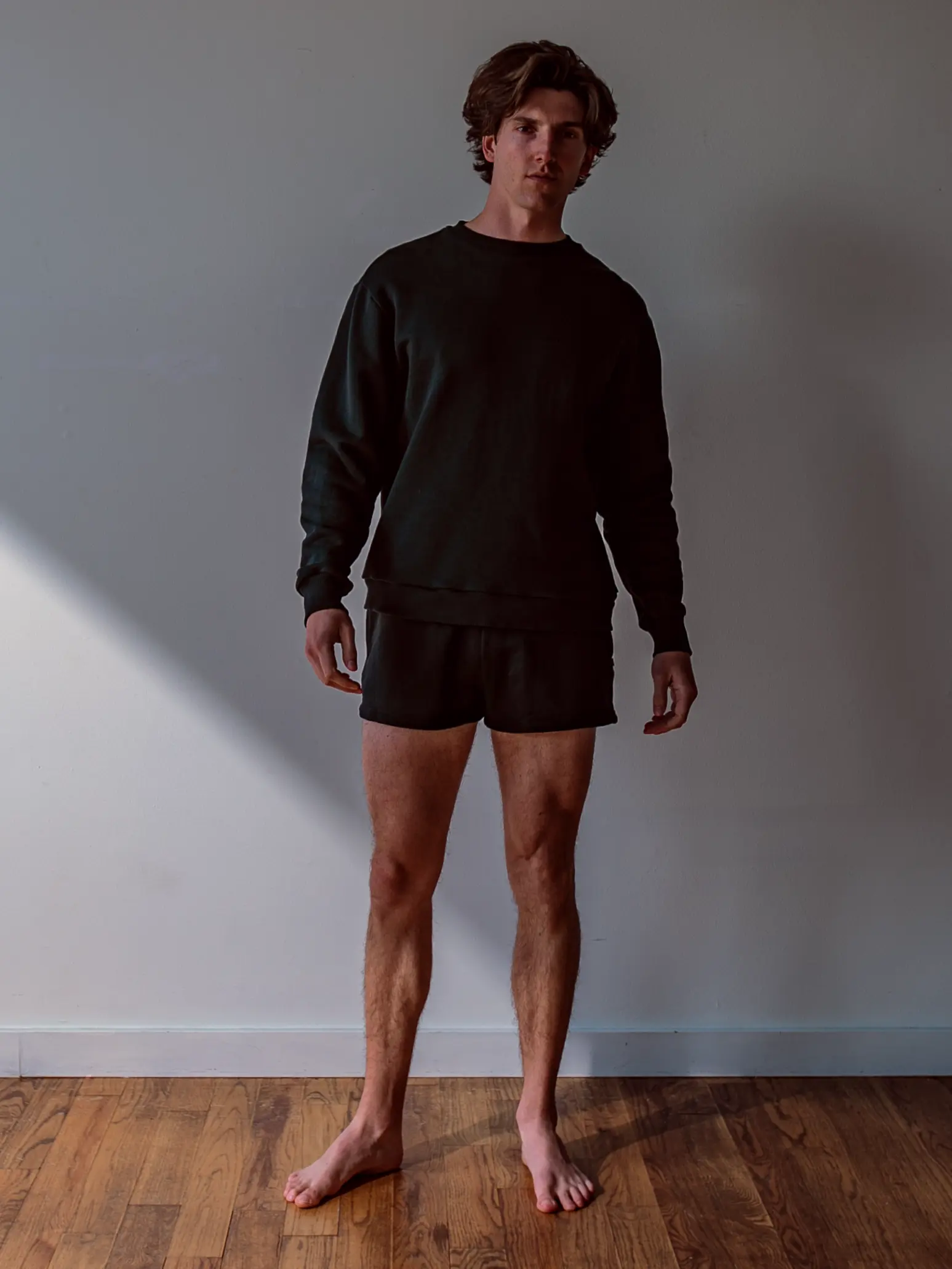 Close-up of a single green leaf against a white background.