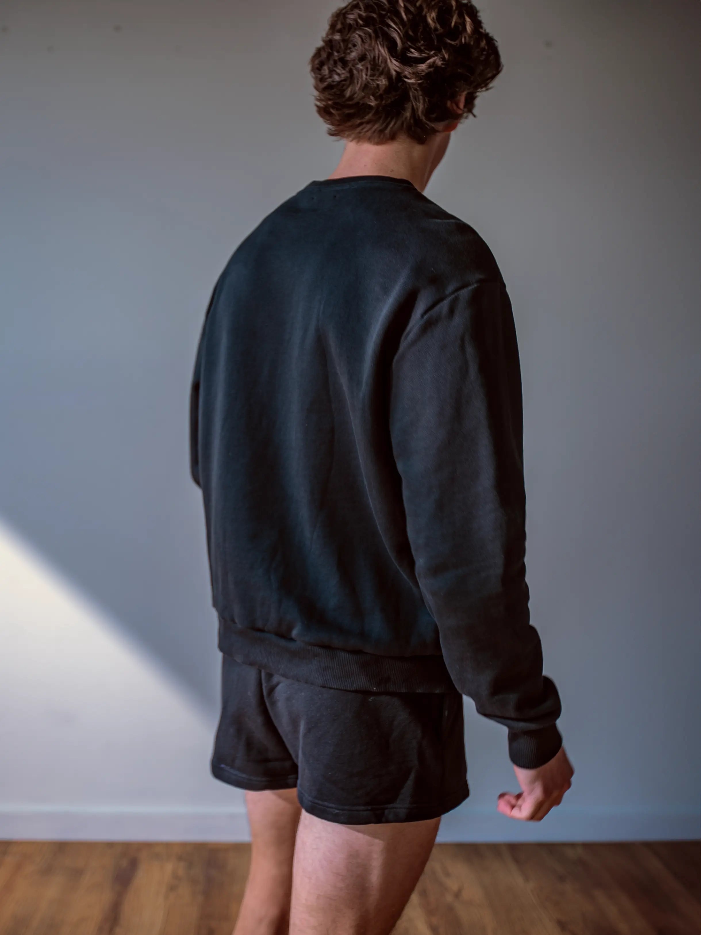 Close-up of a single green leaf against a white background.