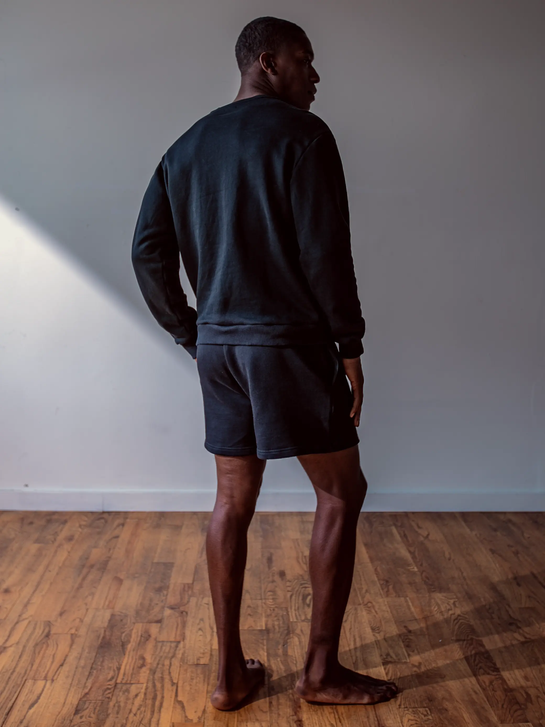 Close-up of a single green leaf against a white background.