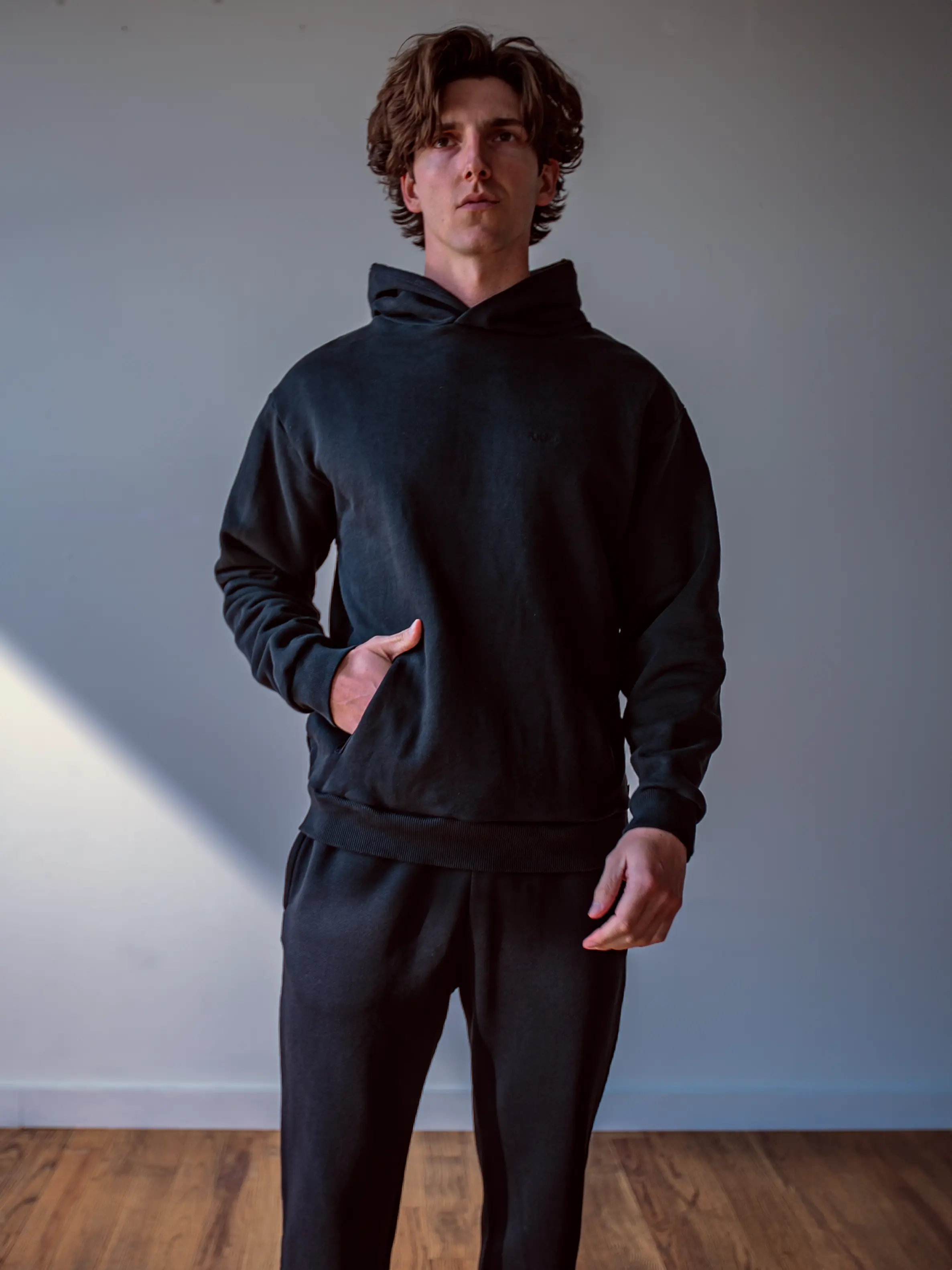 Close-up of a single green leaf against a white background.