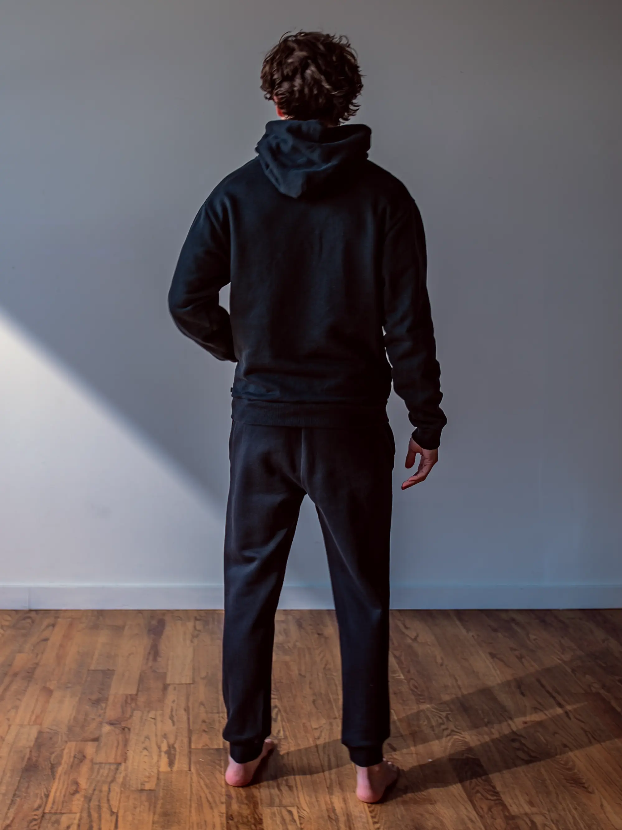 Close-up of a single green leaf against a white background.