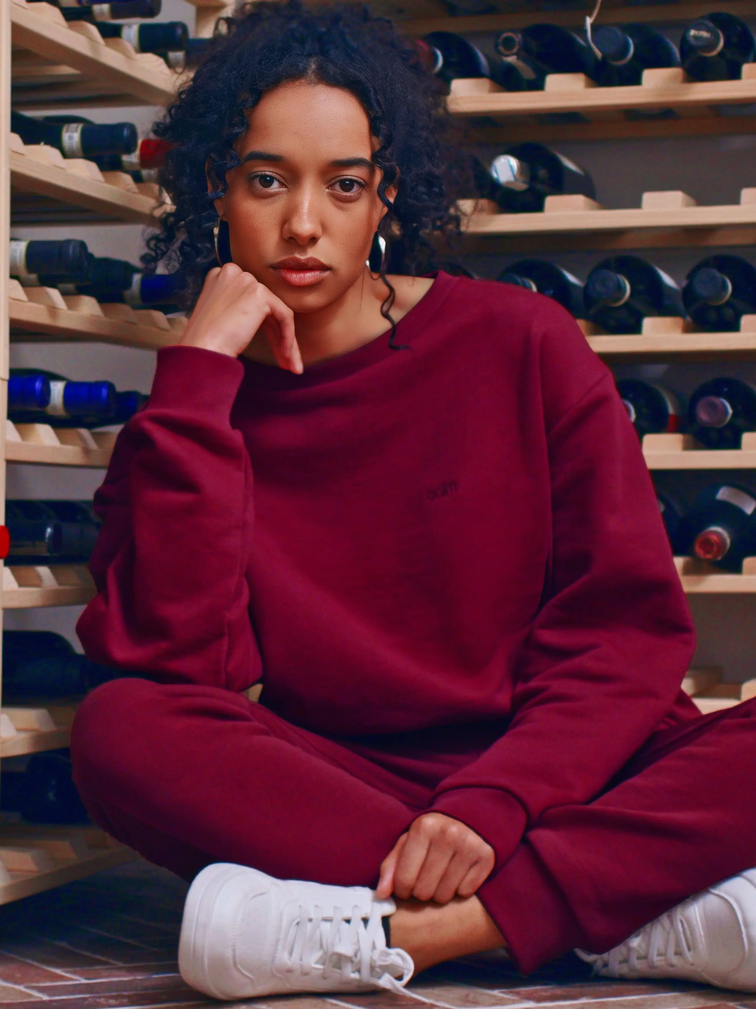 Cream-colored hoodie on a wood-textured background.