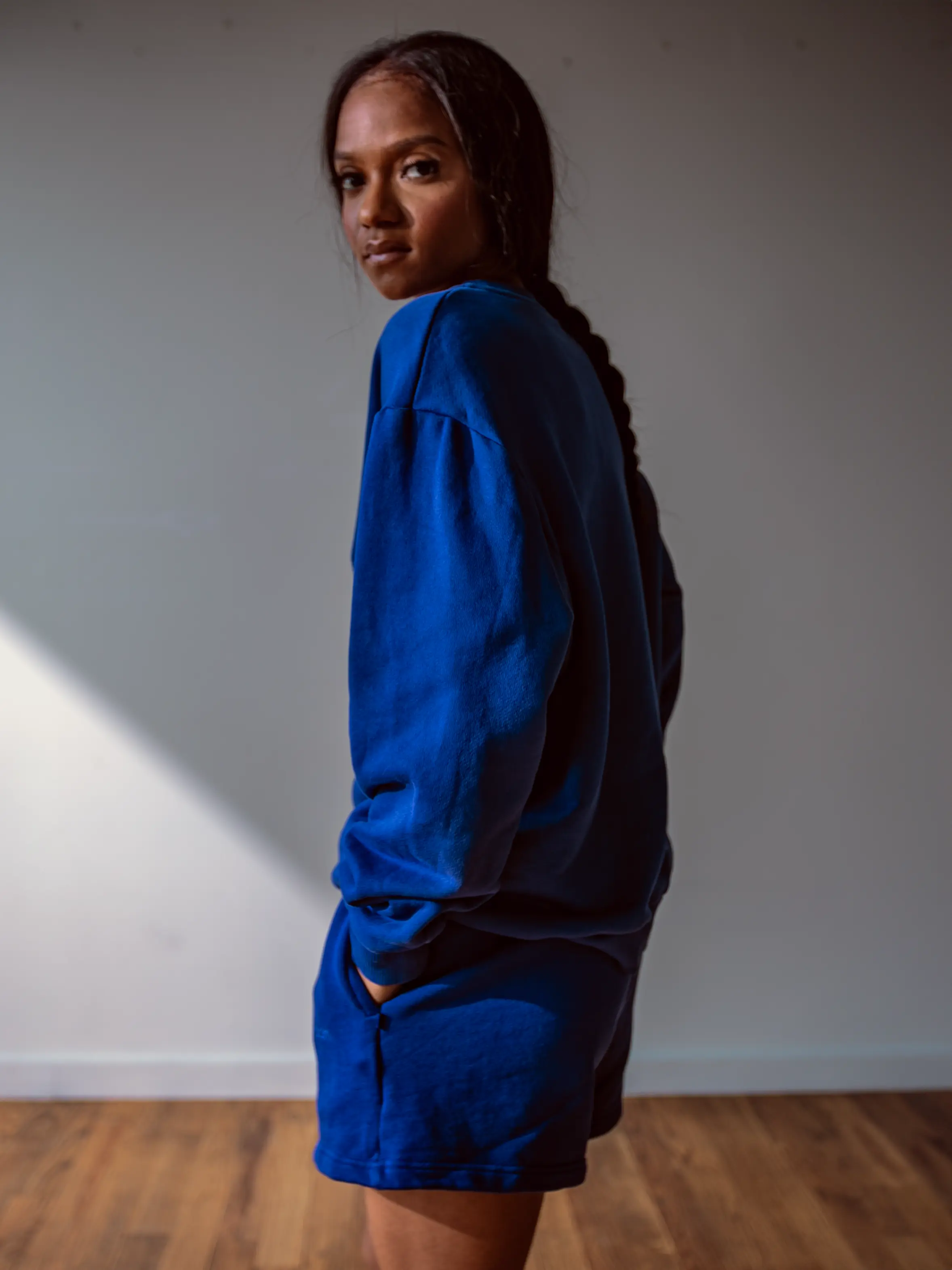 Close-up of a single green leaf against a white background.