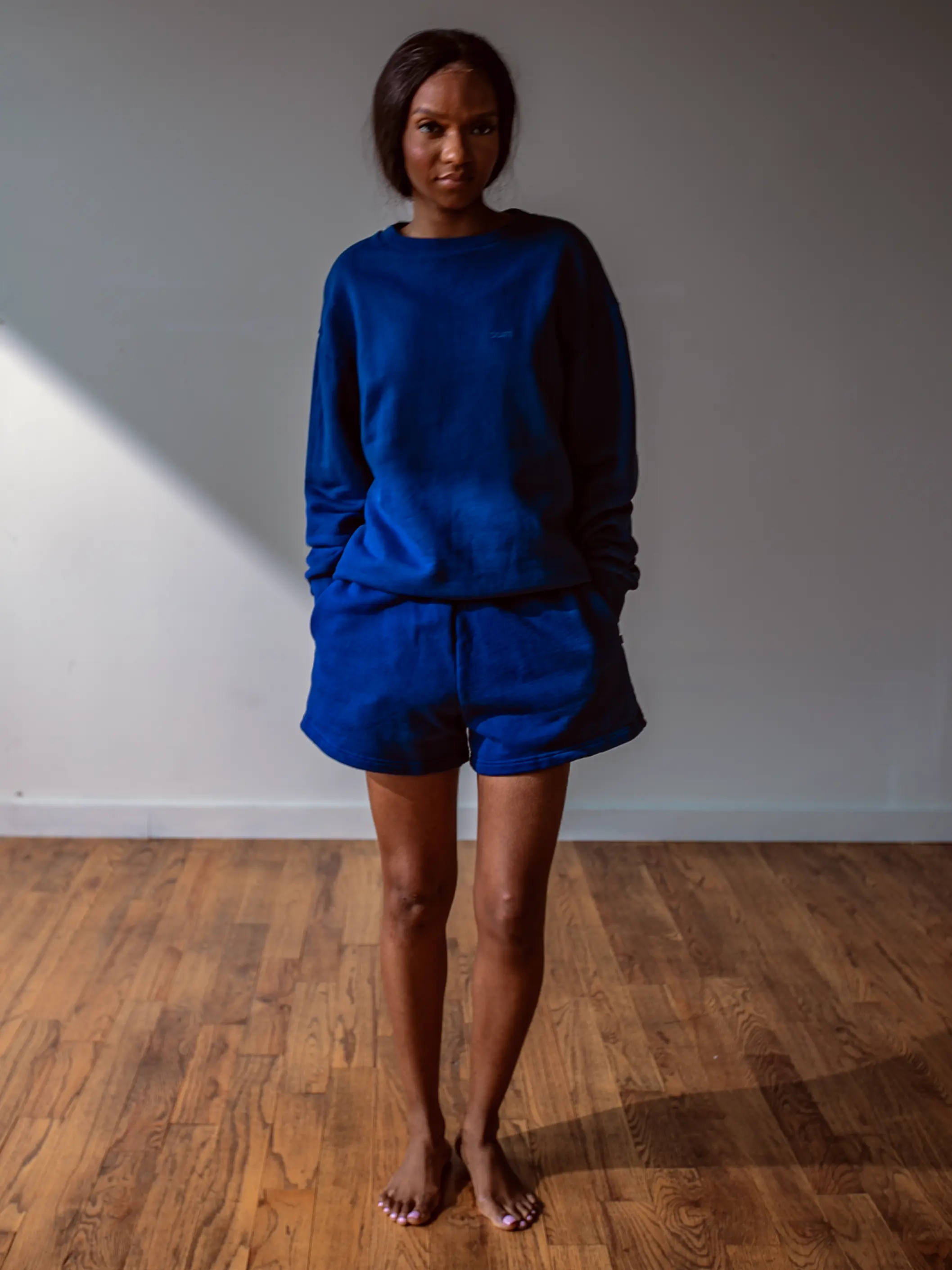 Close-up of a single green leaf against a white background.