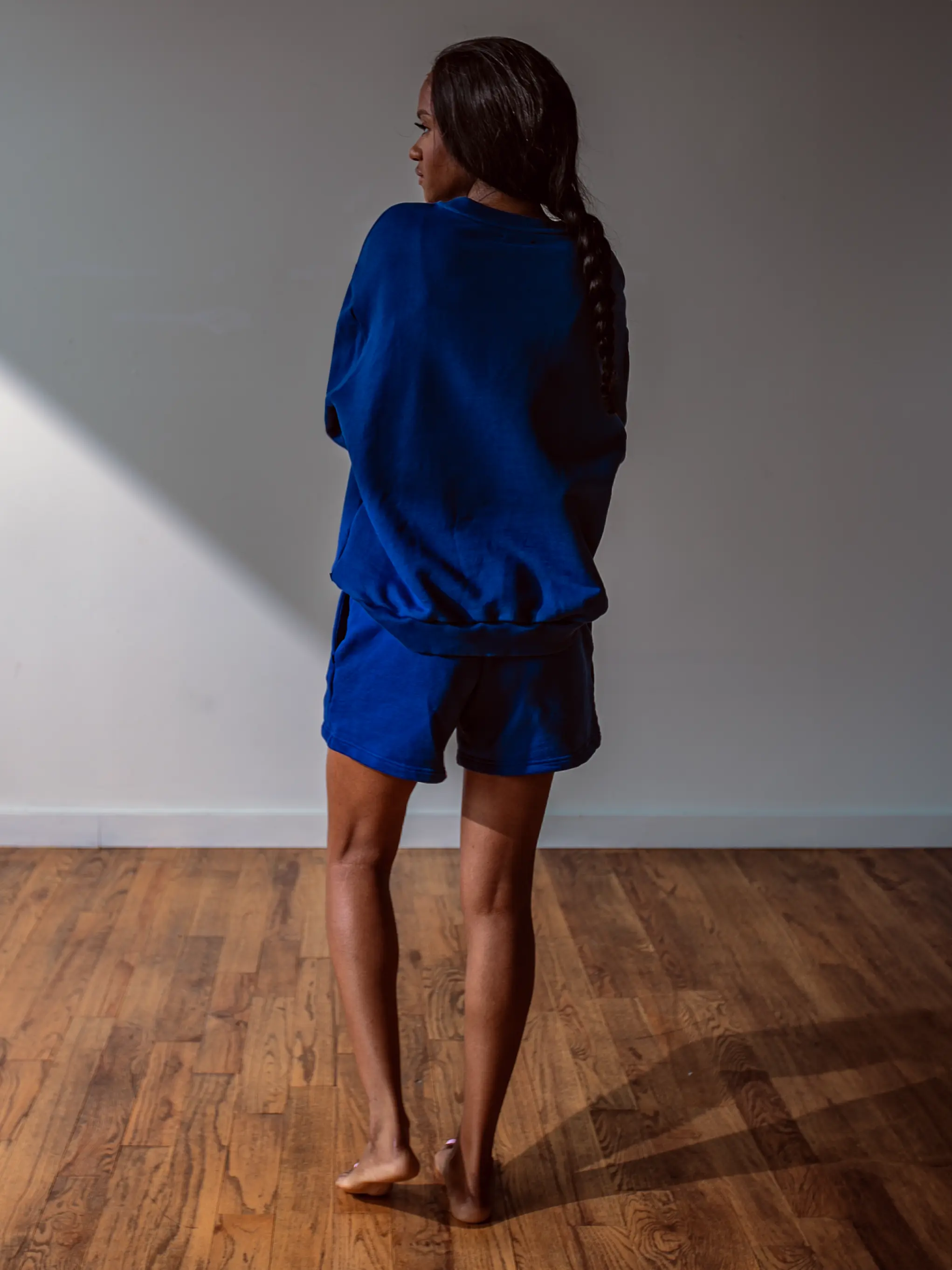 Close-up of a single green leaf against a white background.