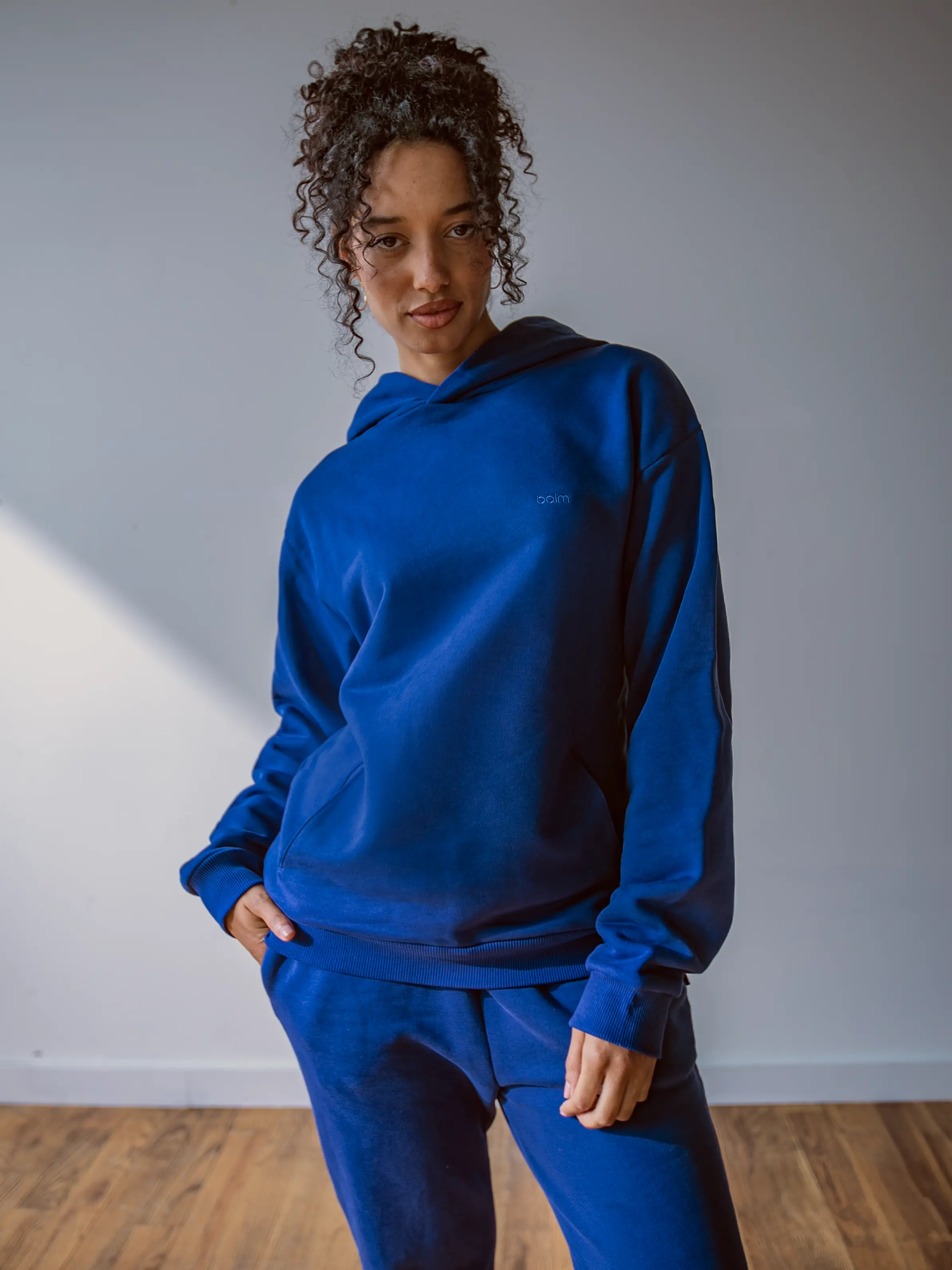 Close-up of a single green leaf against a white background.