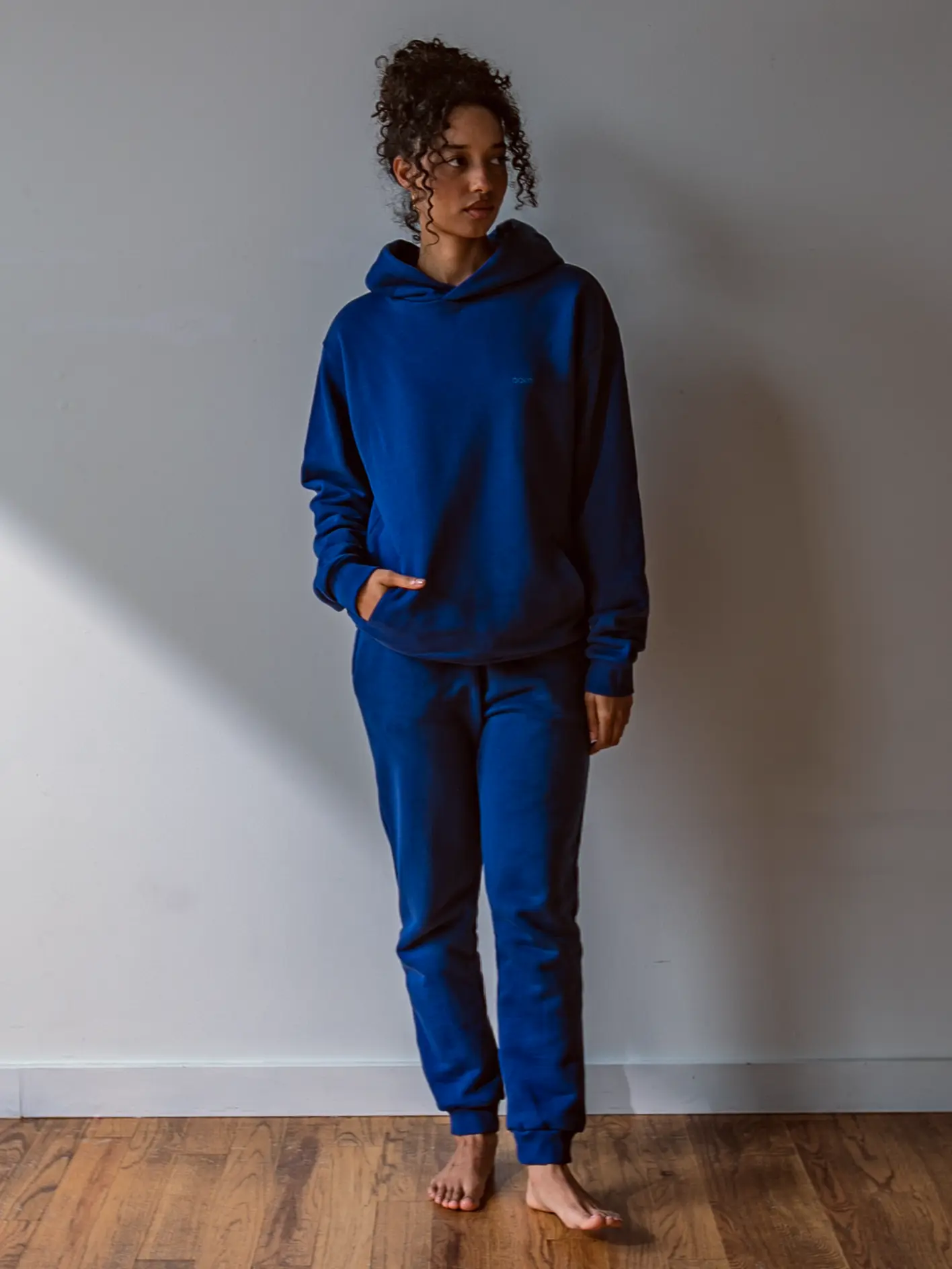 Close-up of a single green leaf against a white background.