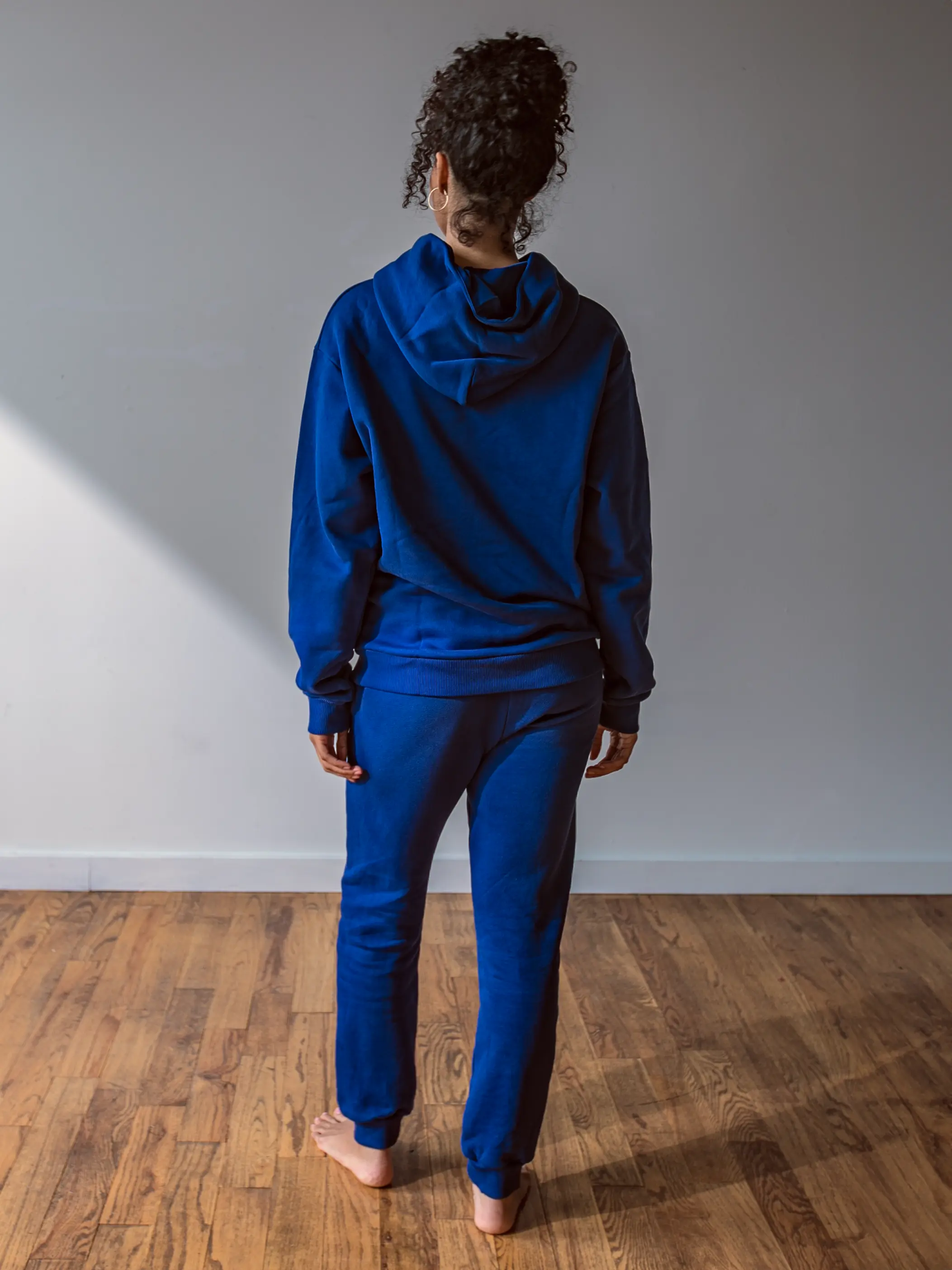 Close-up of a single green leaf against a white background.