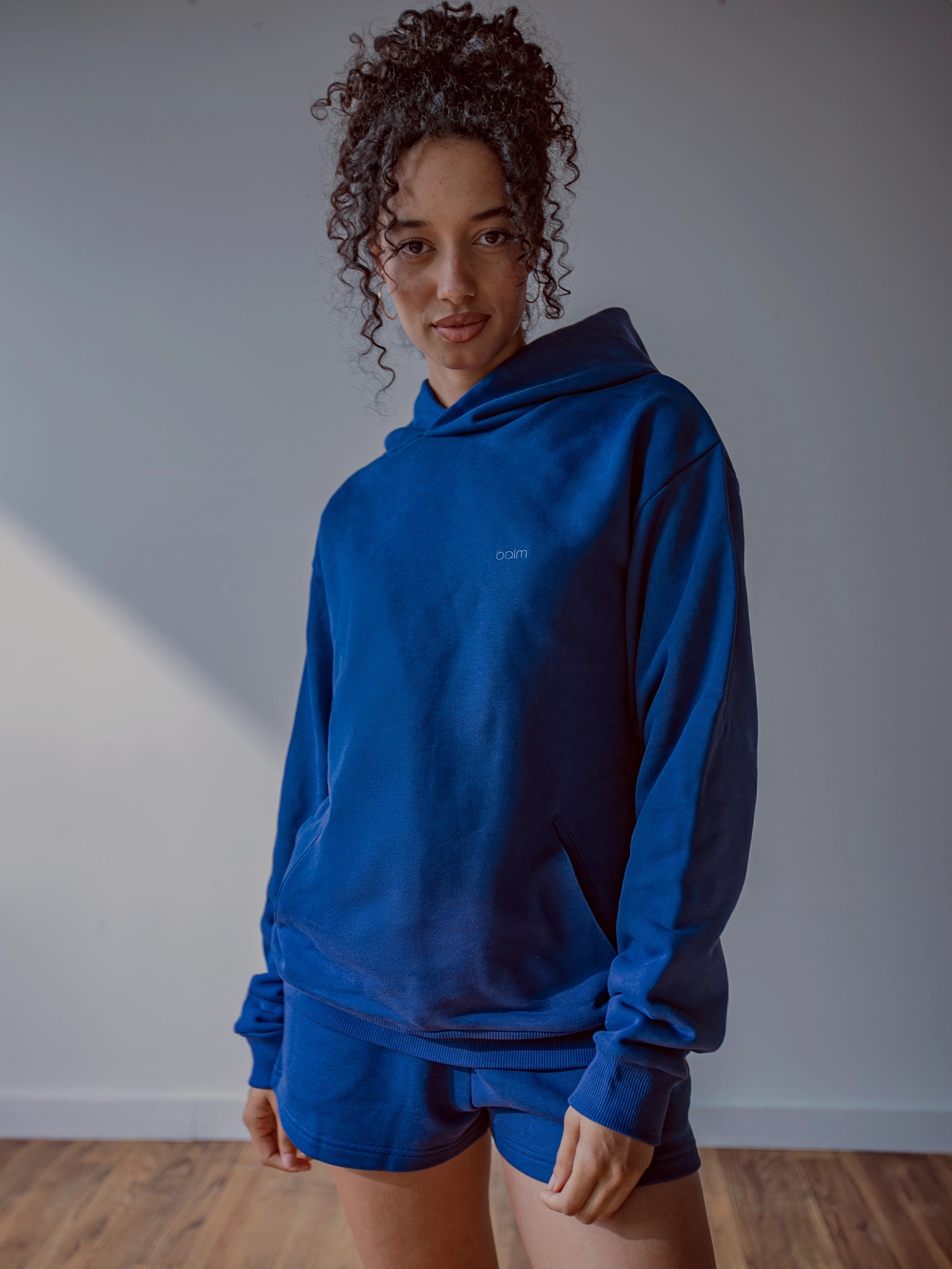 Close-up of a single green leaf against a white background.