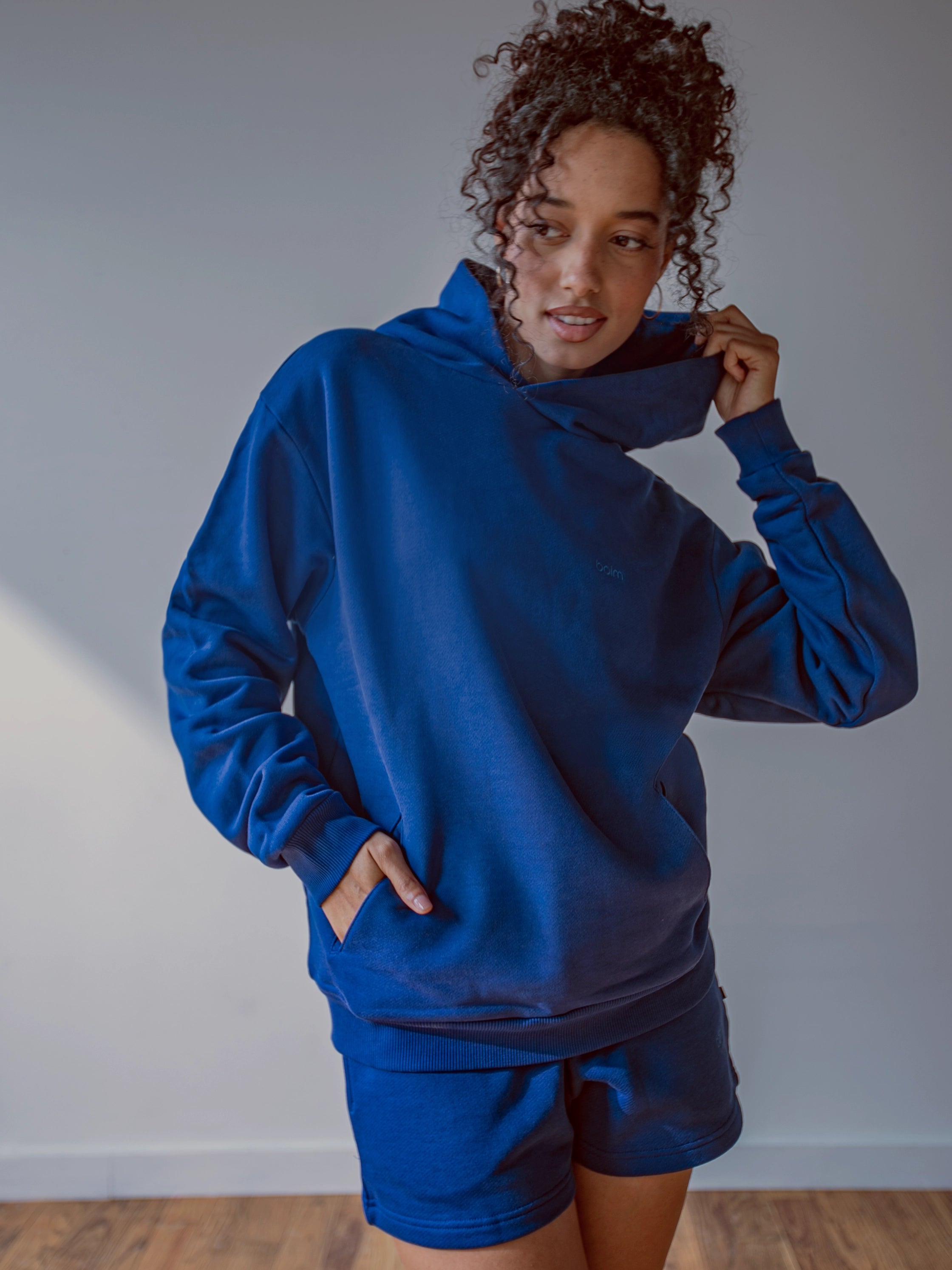 Close-up of a single green leaf against a white background.