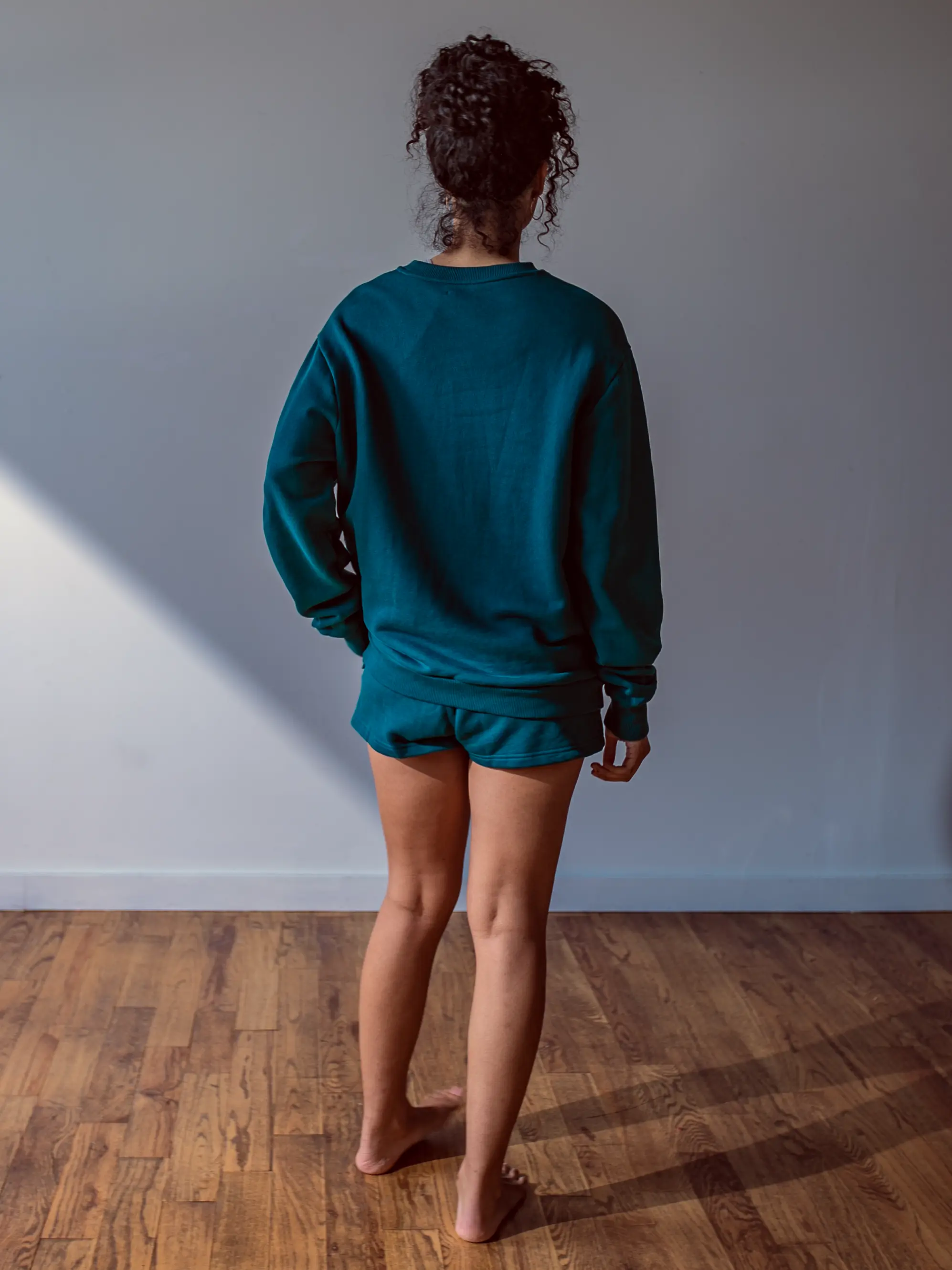 Close-up of a single green leaf against a white background.