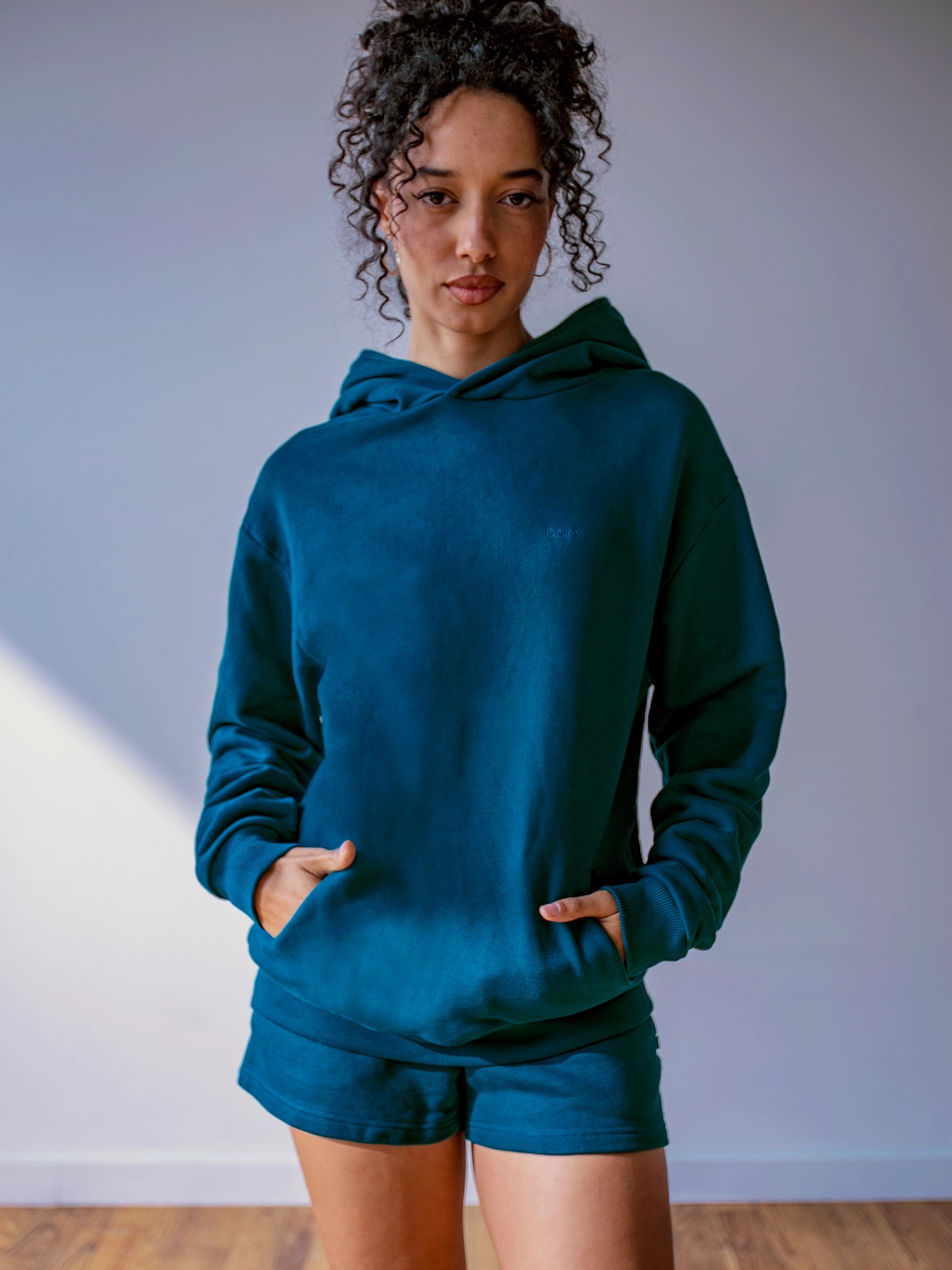 Close-up of a single green leaf against a white background.