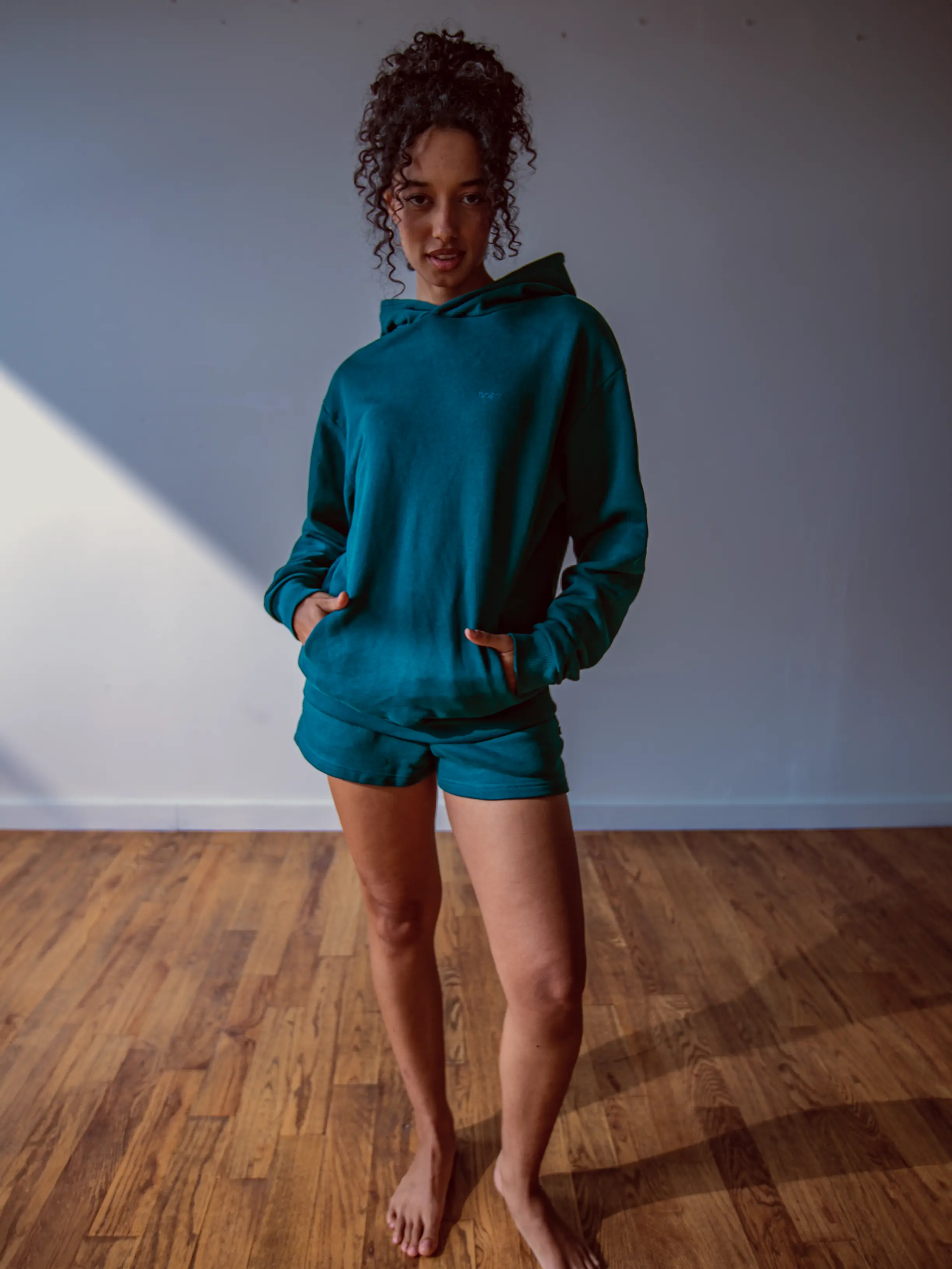 Close-up of a single green leaf against a white background.