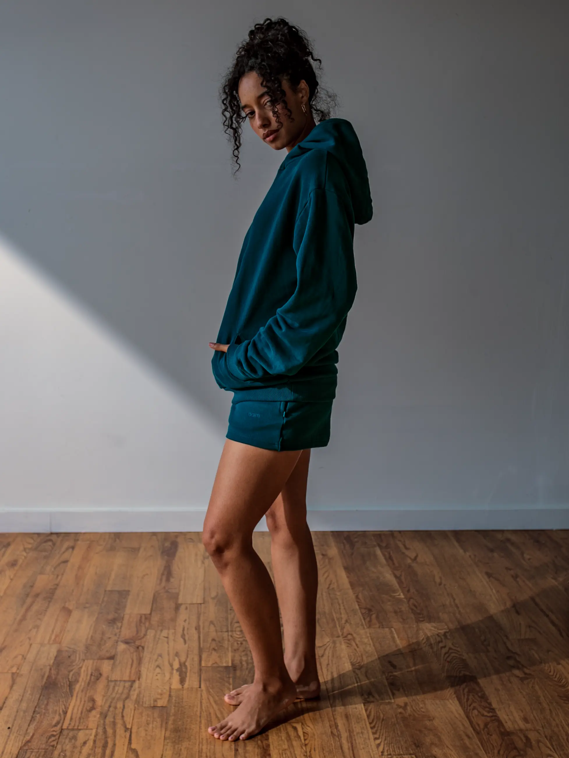 Close-up of a single green leaf against a white background.
