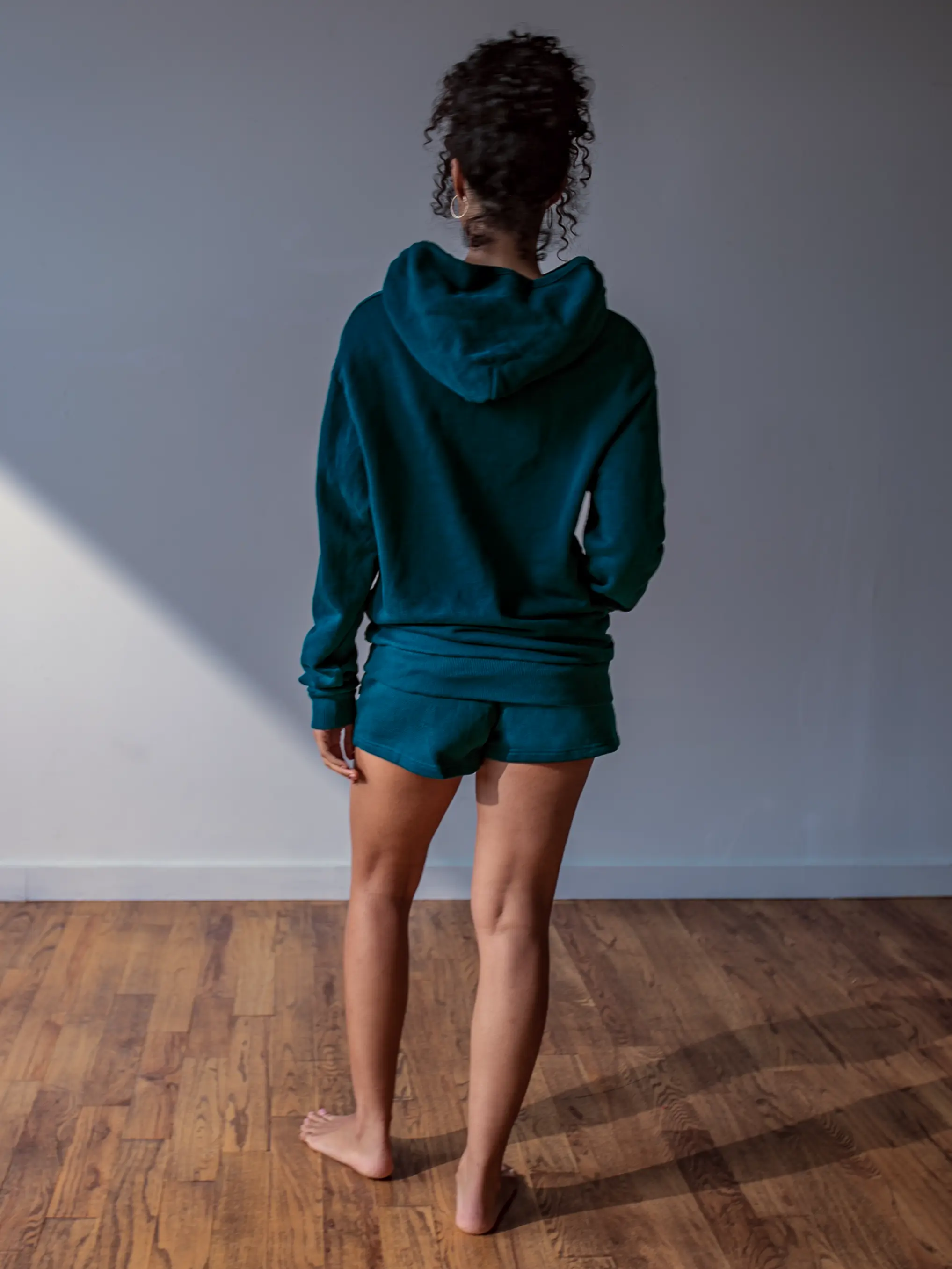 Close-up of a single green leaf against a white background.