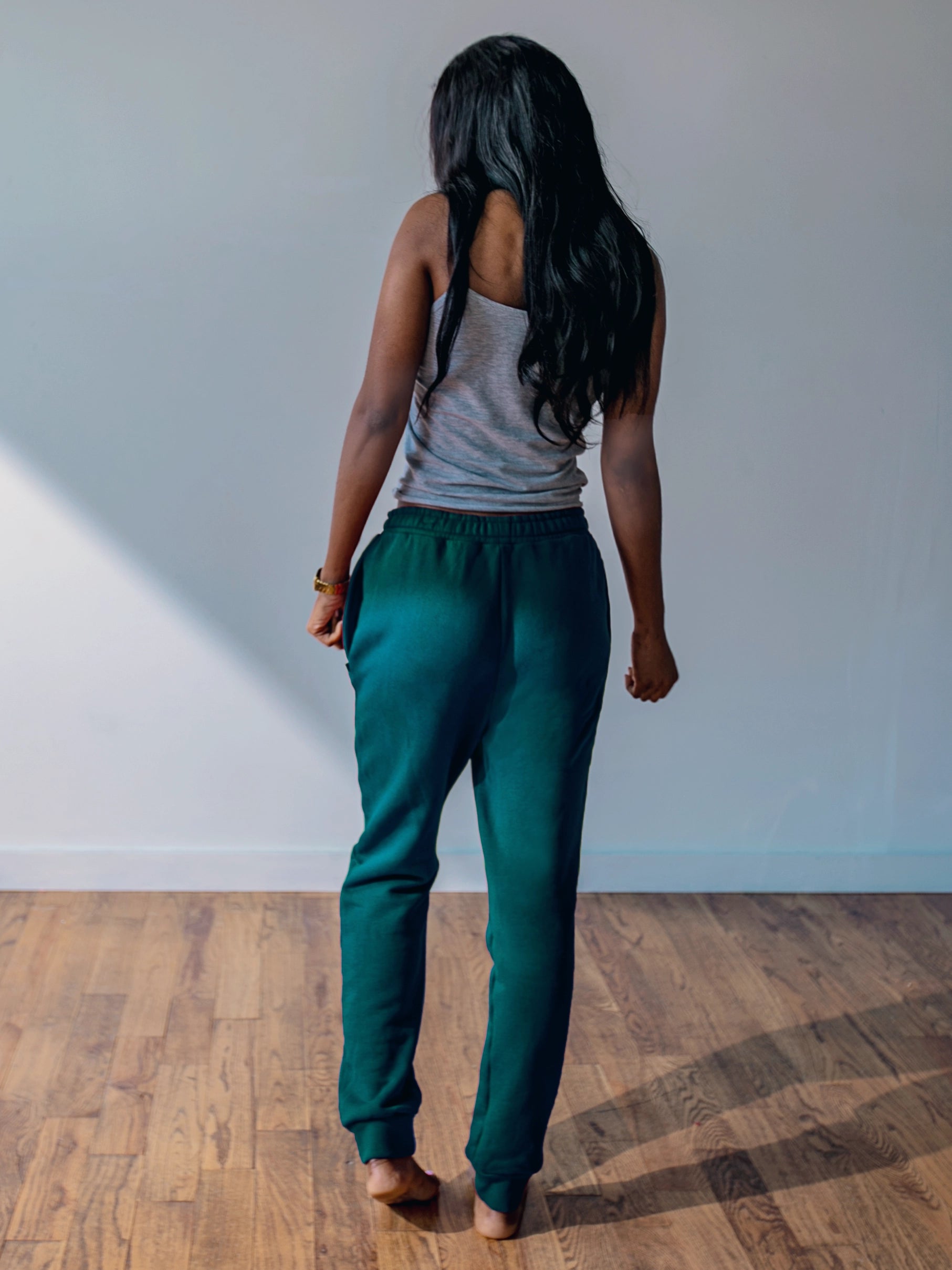 Close-up of a single green leaf against a white background.