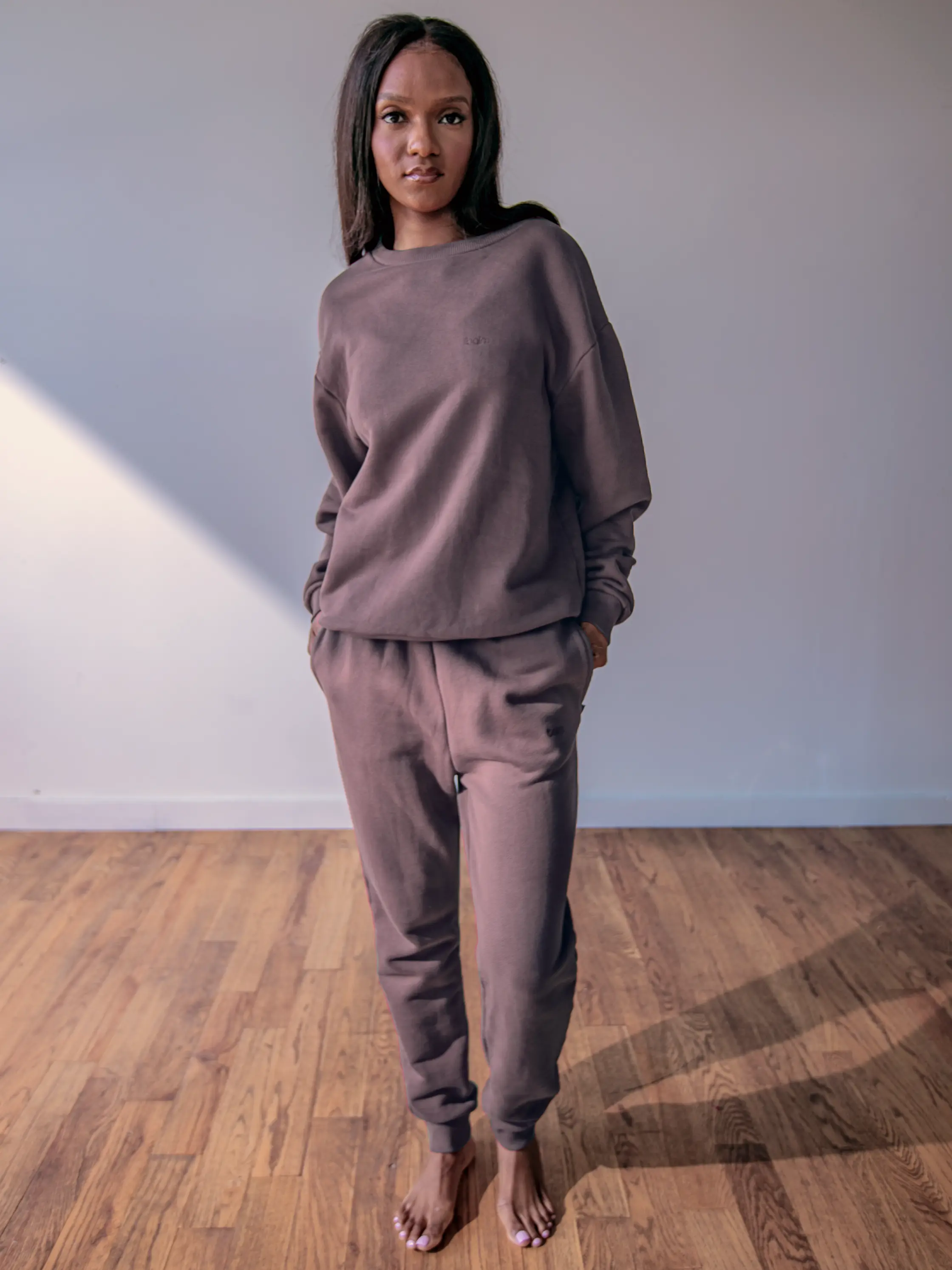 Close-up of a single green leaf against a white background.