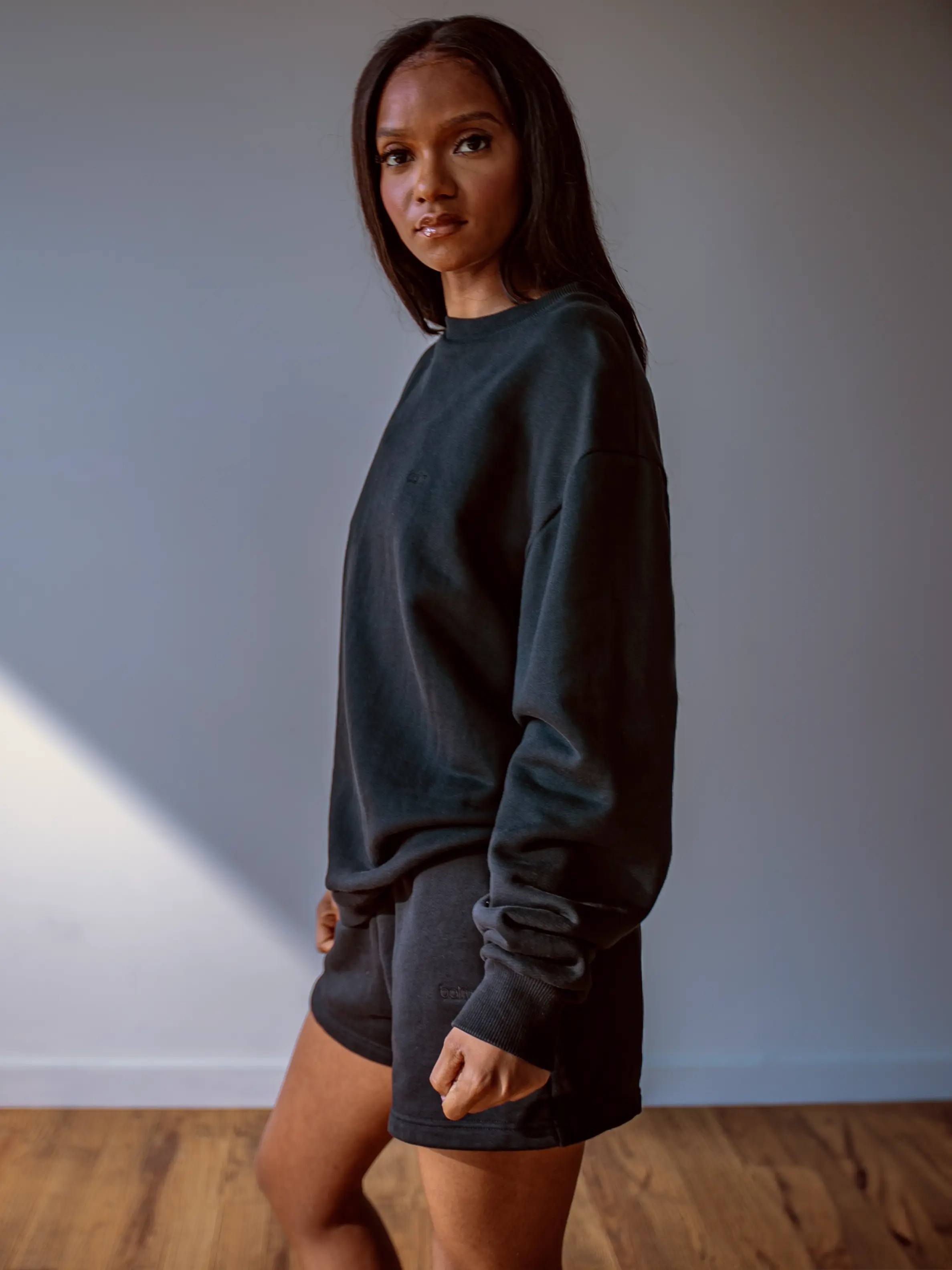 Close-up of a single green leaf against a white background.